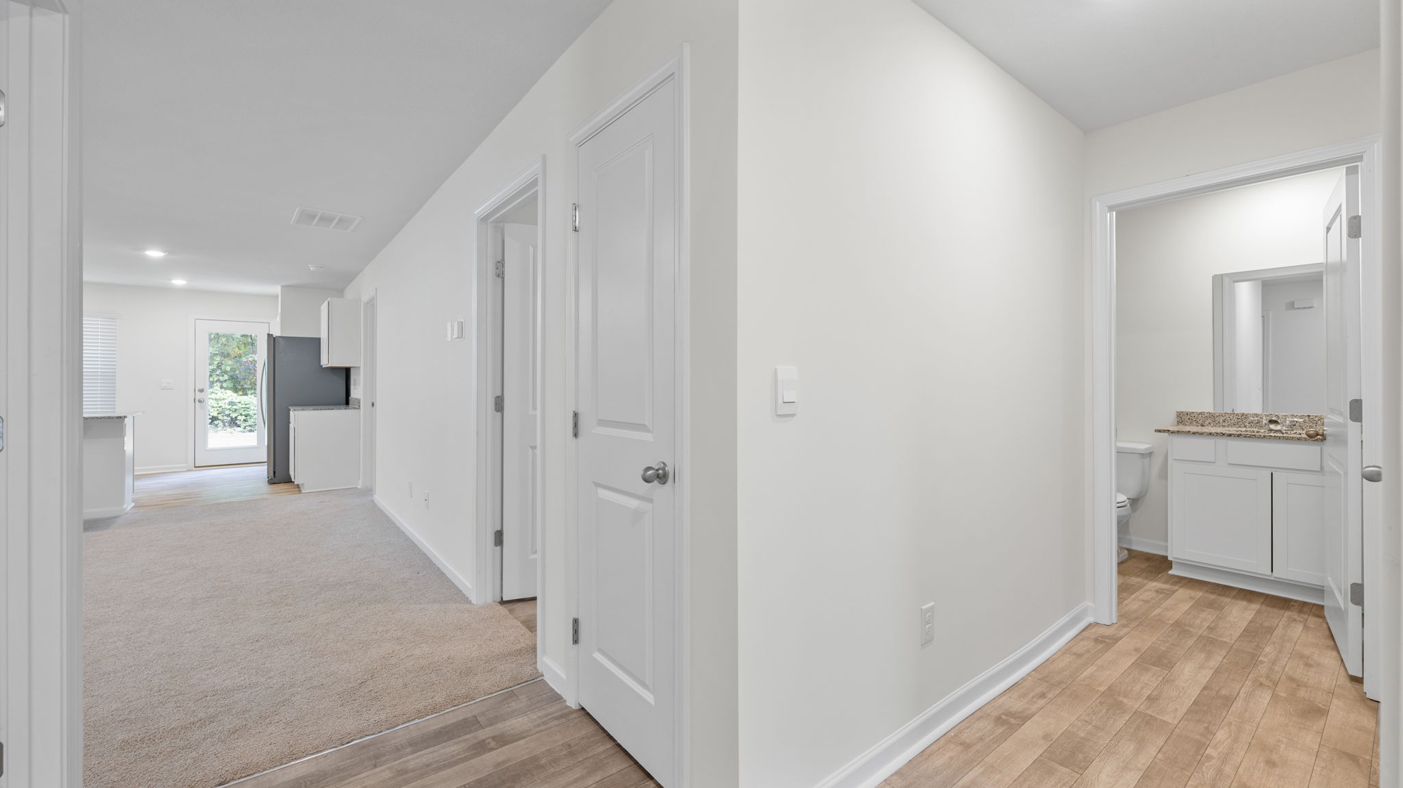 hallway opens to kitchen and bedroom