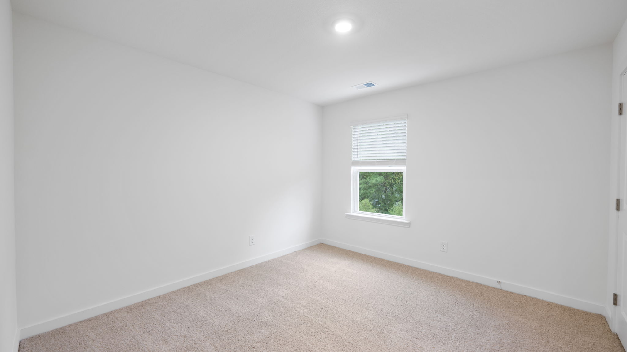 bedroom with single window and walk-in closet