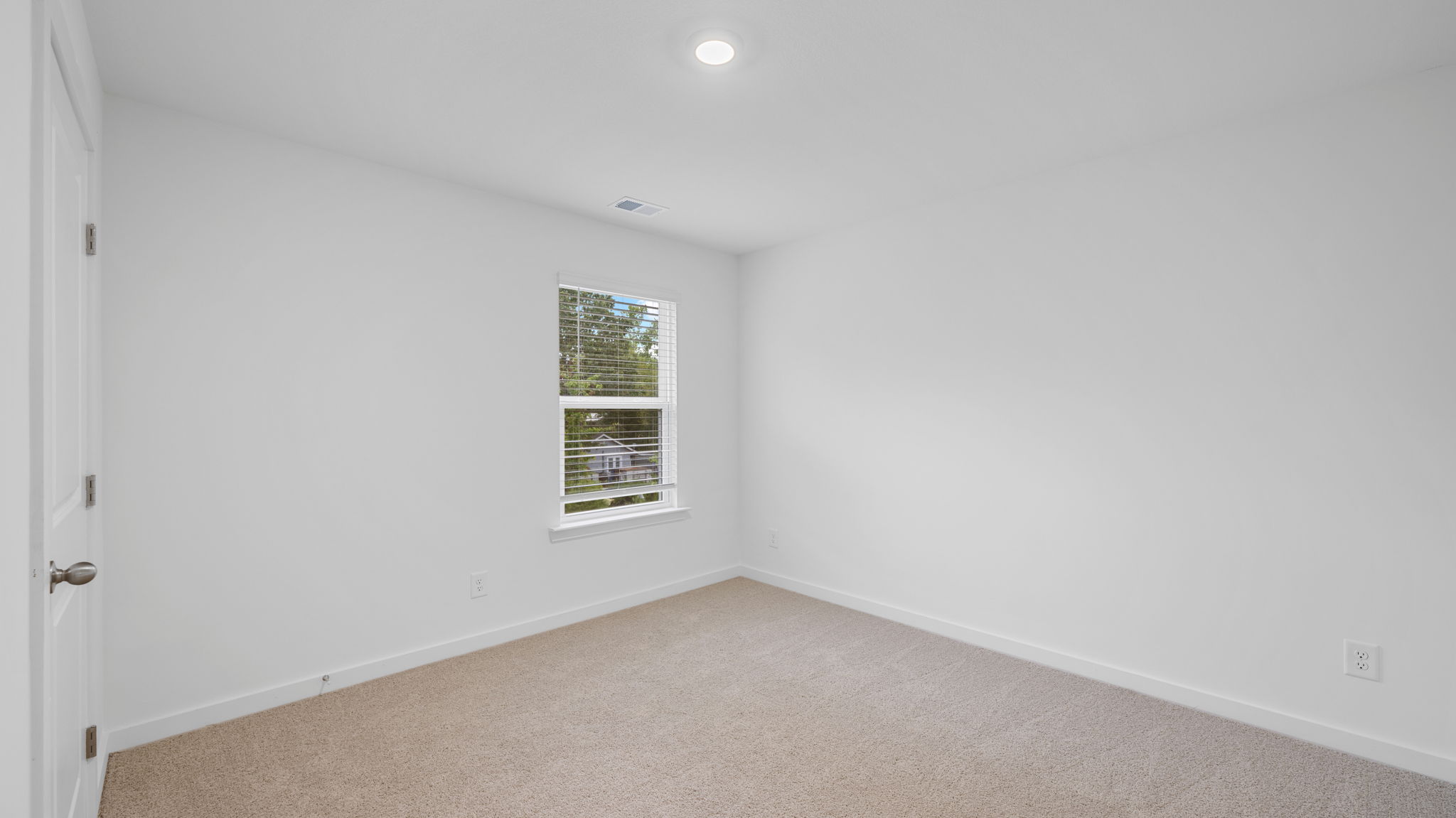 bedroom with single window and walk-in closet
