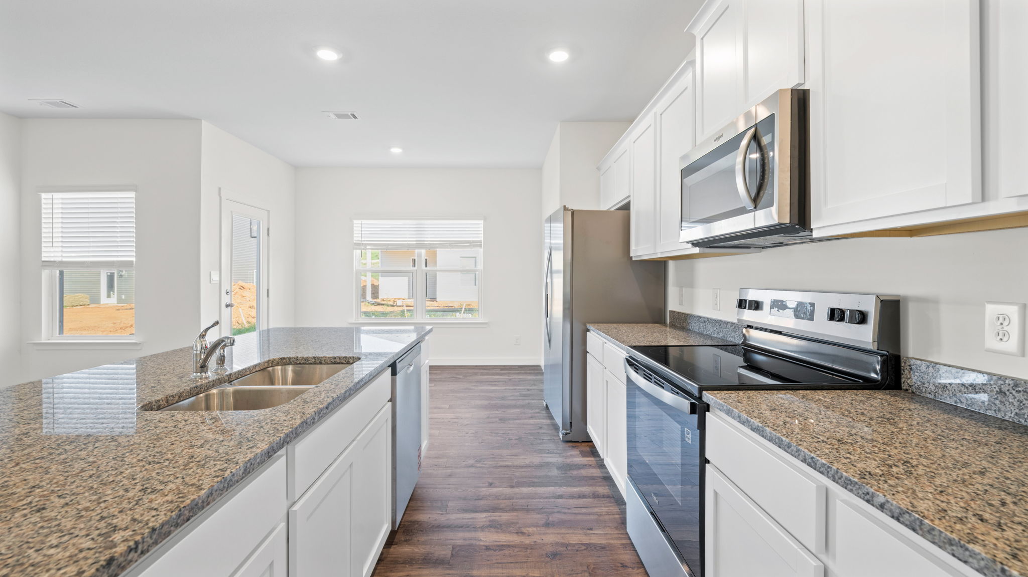 open concept kitchen with large island and stainless steel appliances