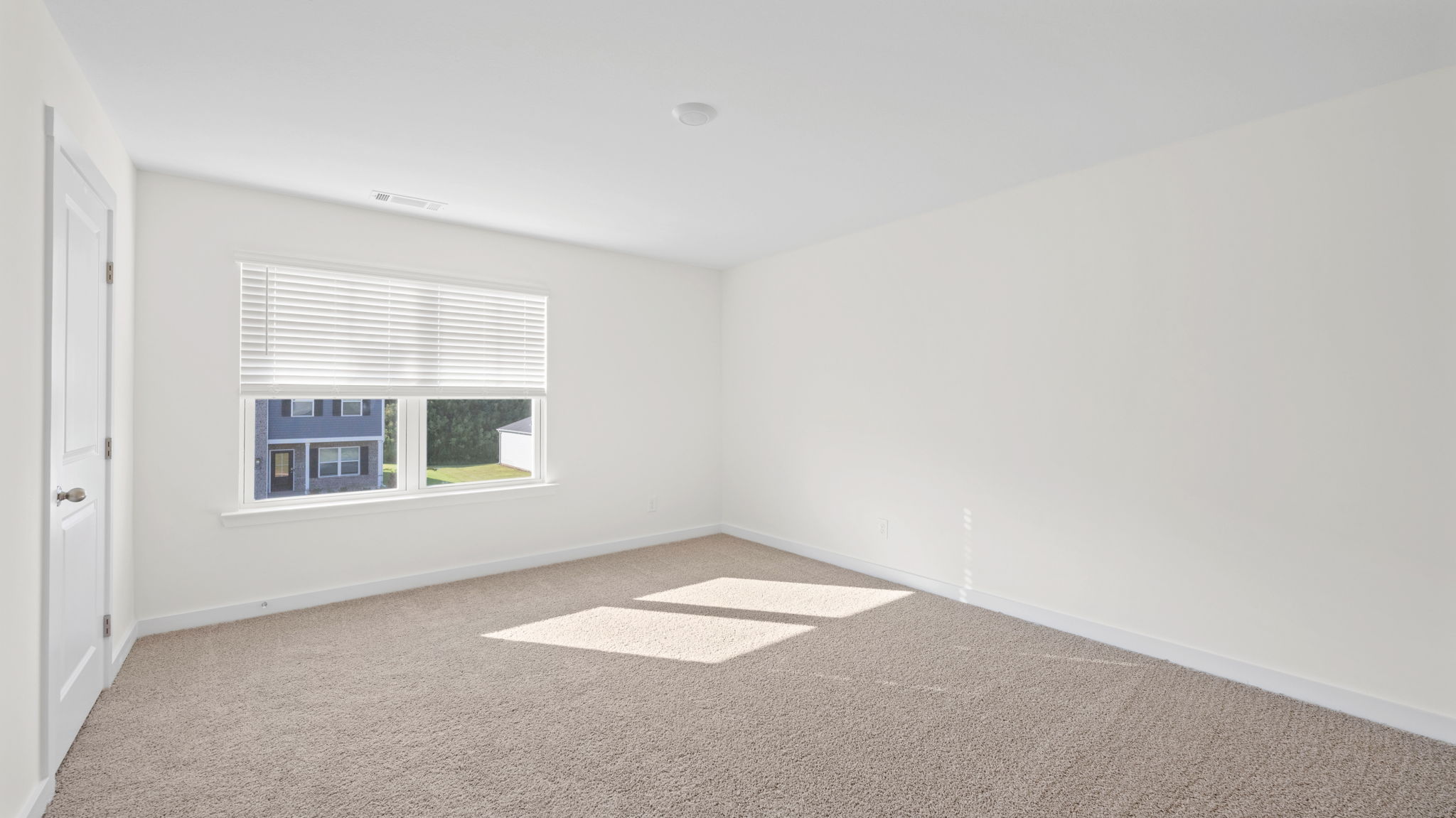 bedroom with double window and walk-in closet