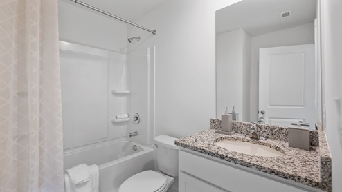 Single vanity bathroom off guest room