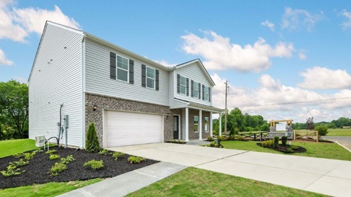 Two story home with two car garage and brick