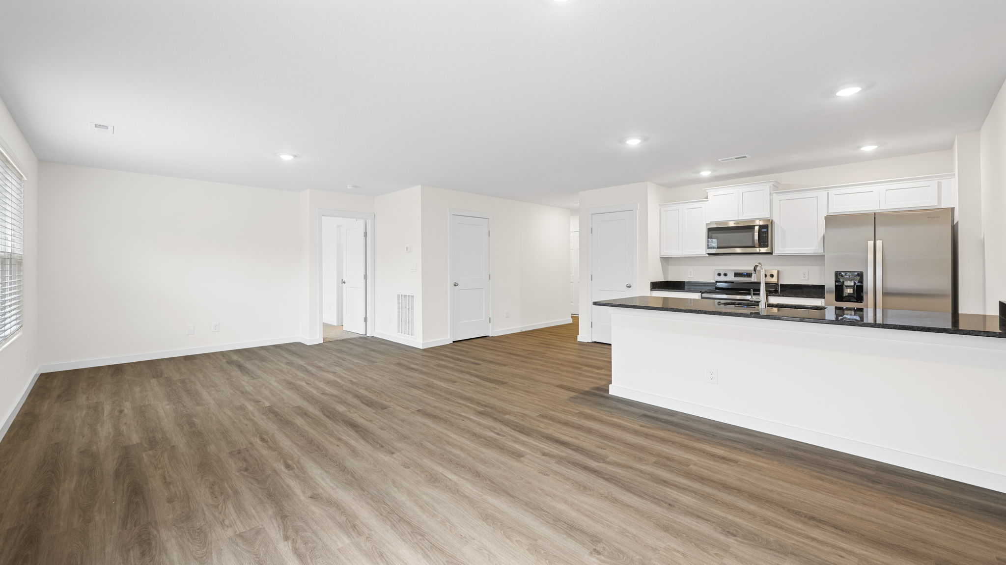 open conept living and dining with double window and back patio door