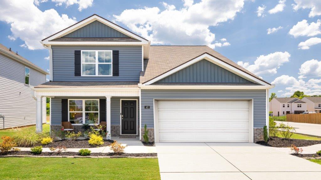Two story home with two car garage and siding