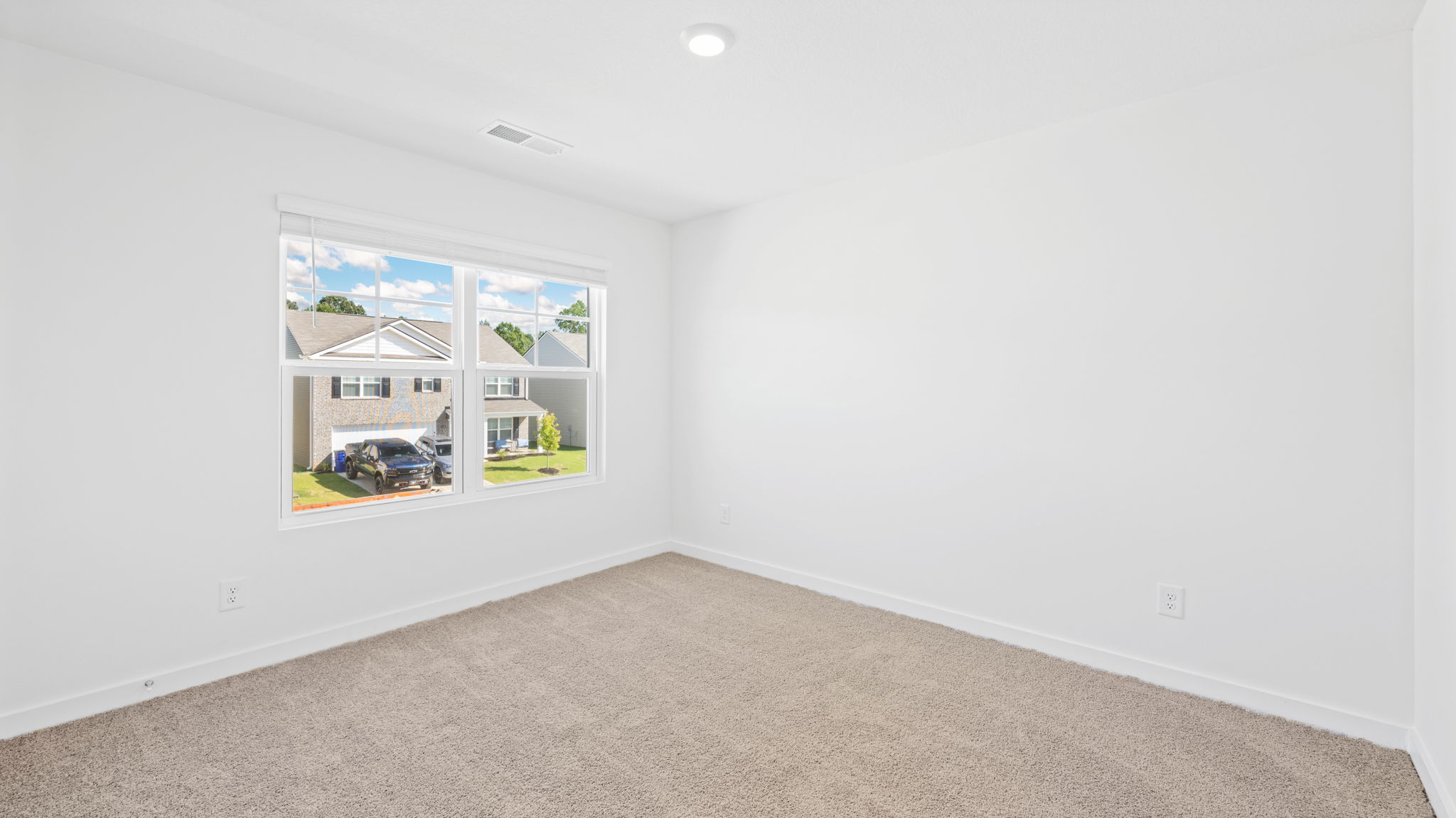bedroom with double window and walk-in closet
