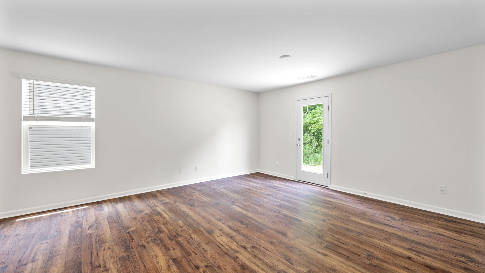 great room has solid flooring and exterior door
