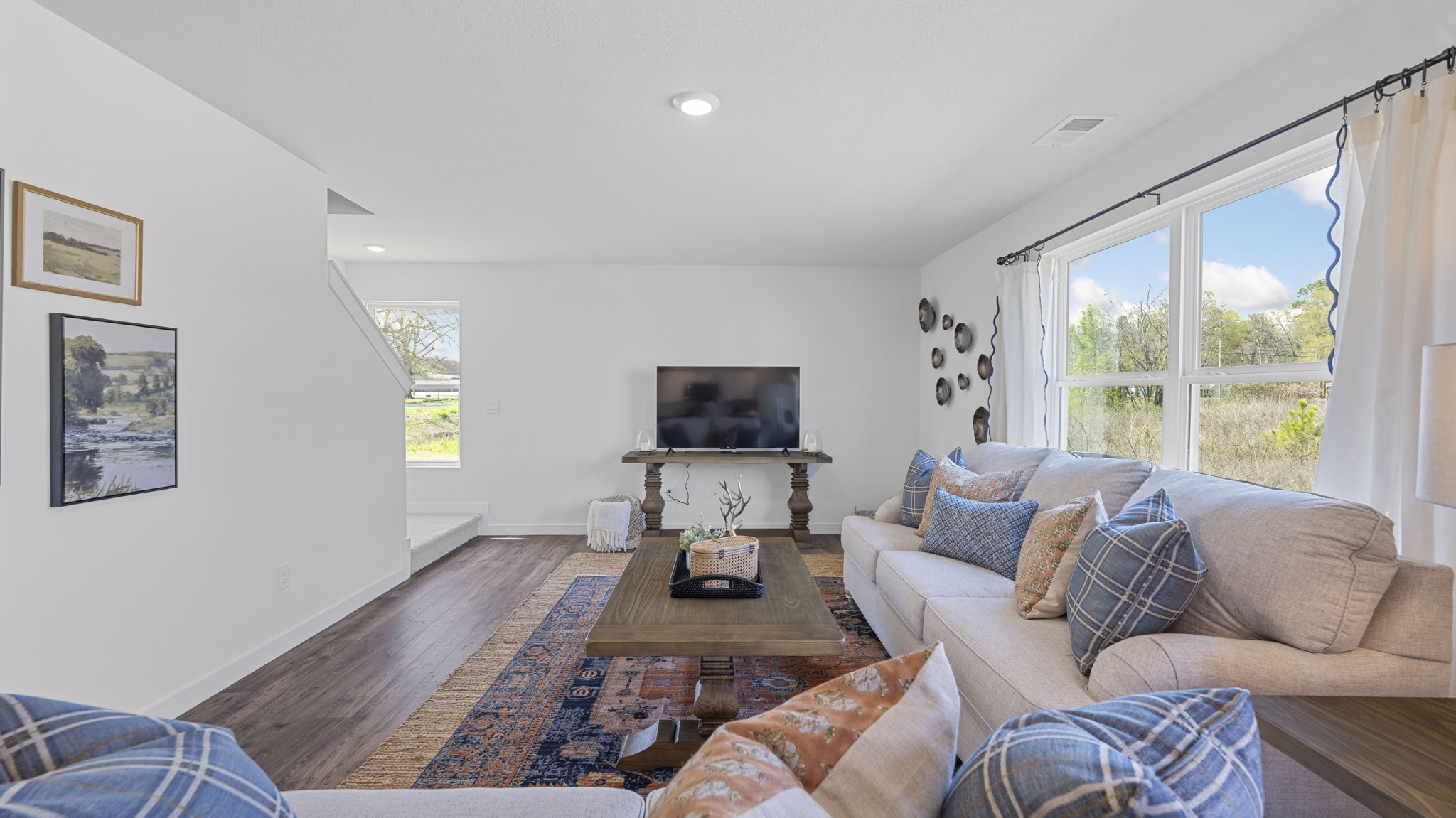 great room with couch and large windows