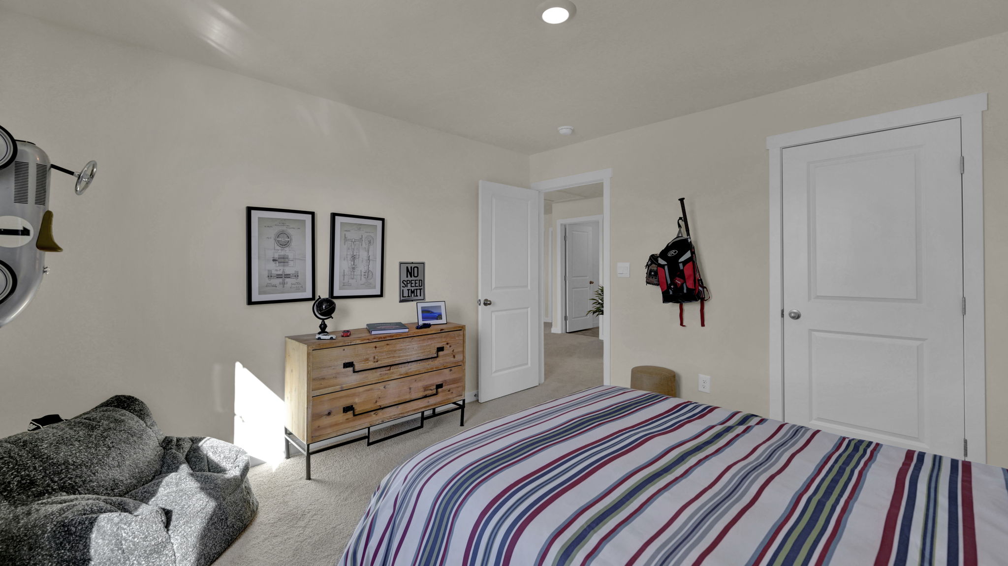 the bedroom has a bed and dresser set