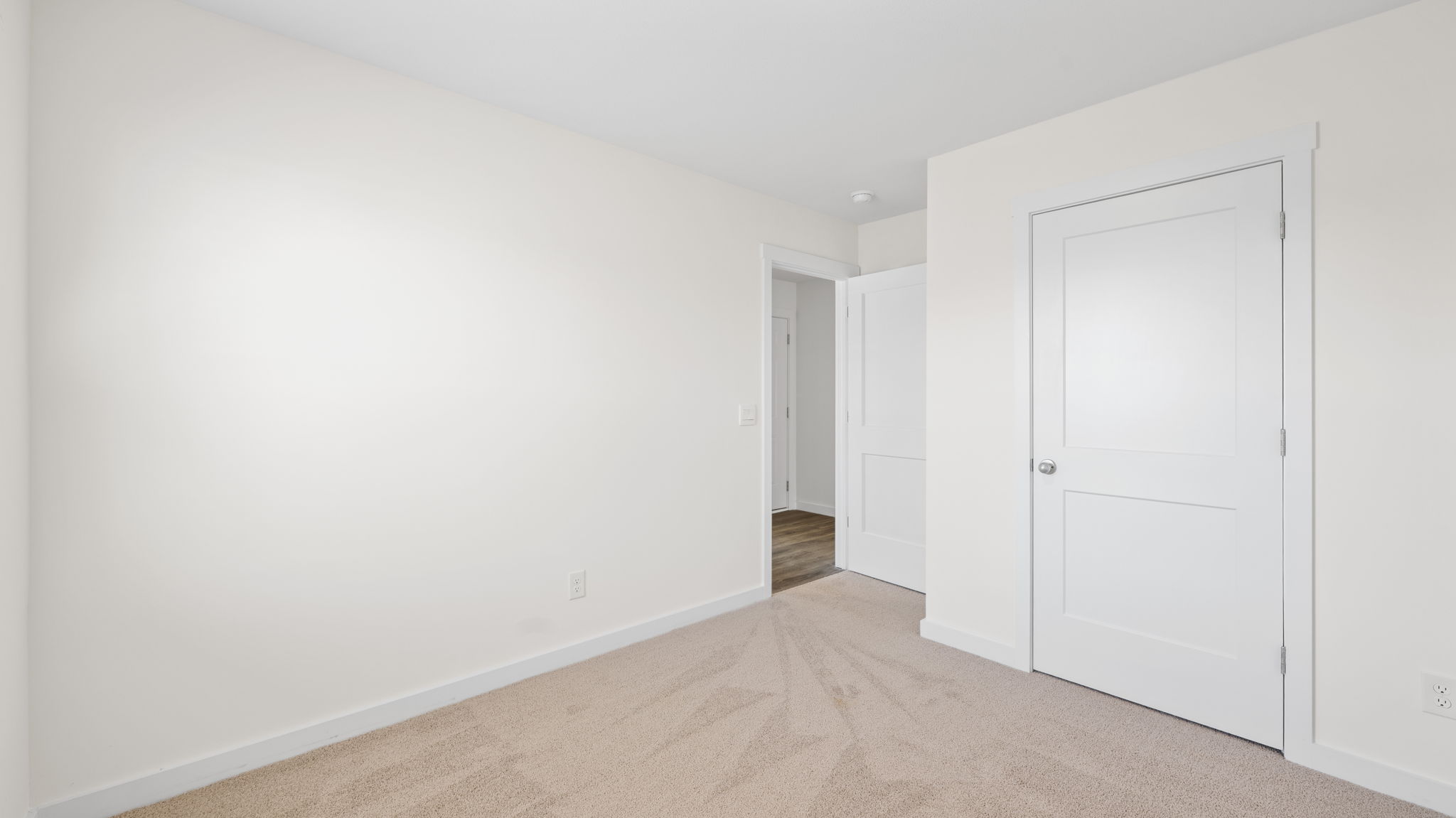 bedroom with carpet and door