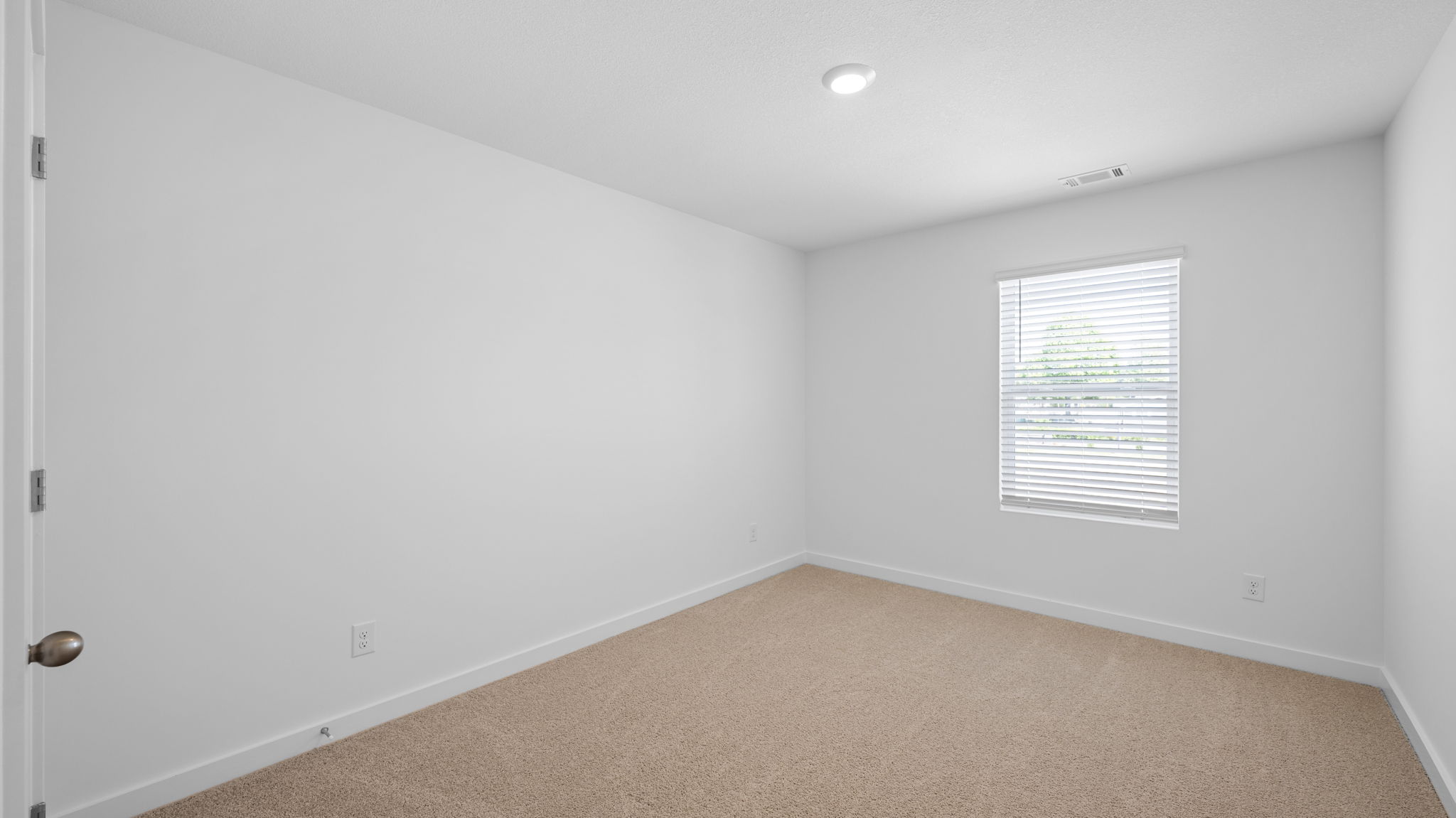 bedroom with single window and walk-in closet