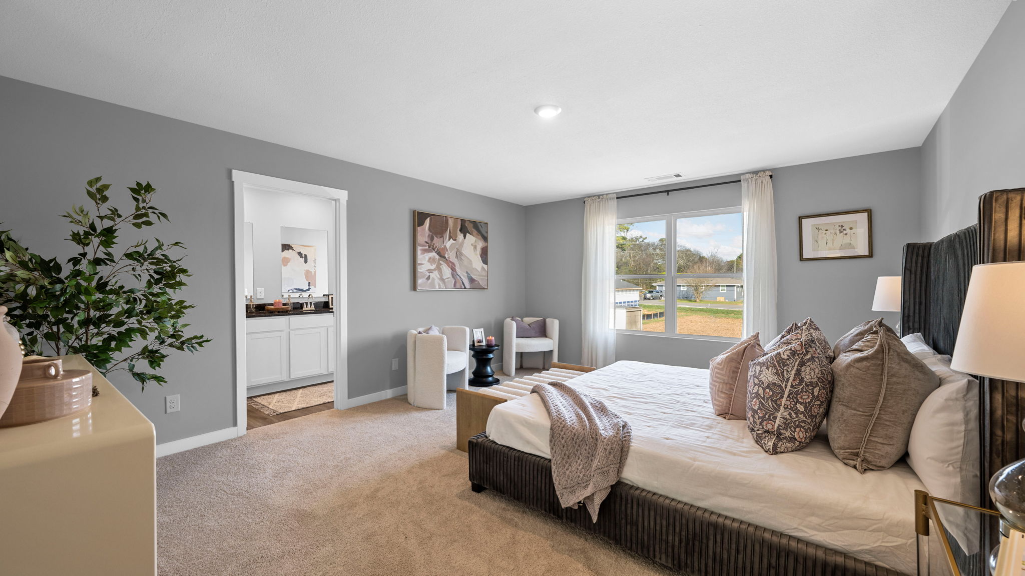 primary bedroom with double window and en suite