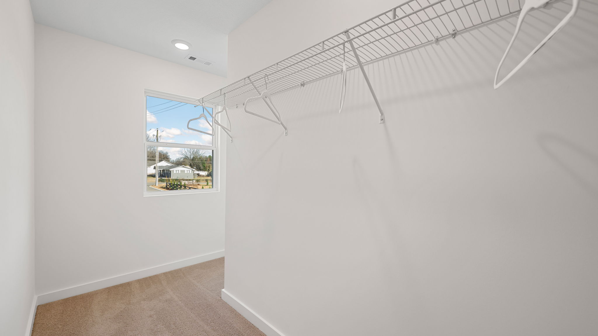 primary bedroom walk-in closet with window