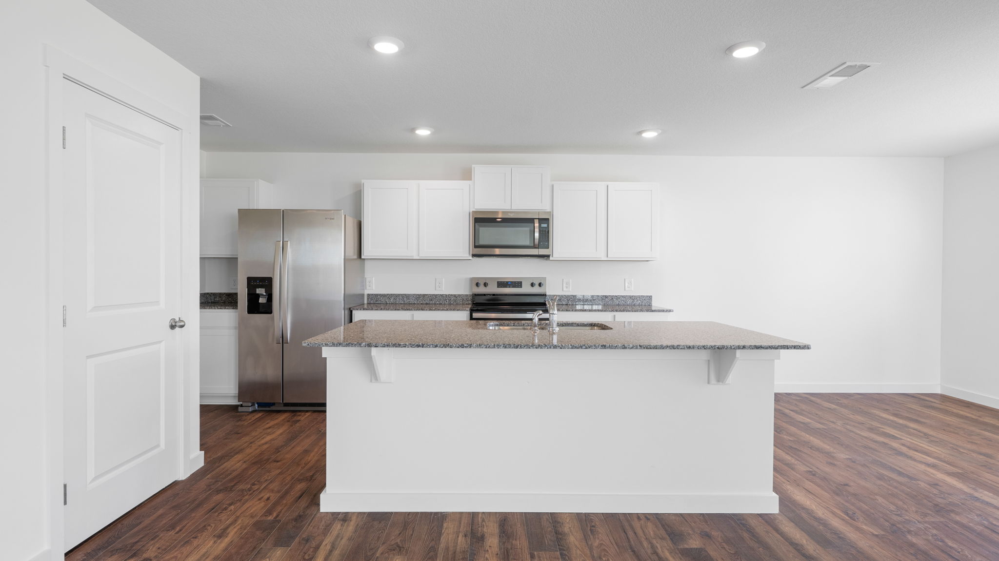 open concept kitchen with stainless steel appliances and large island