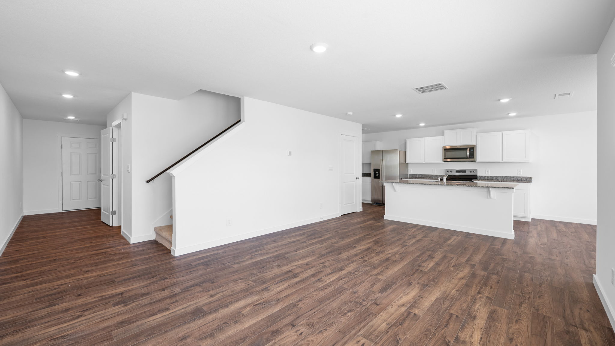 living area opening into kitchen