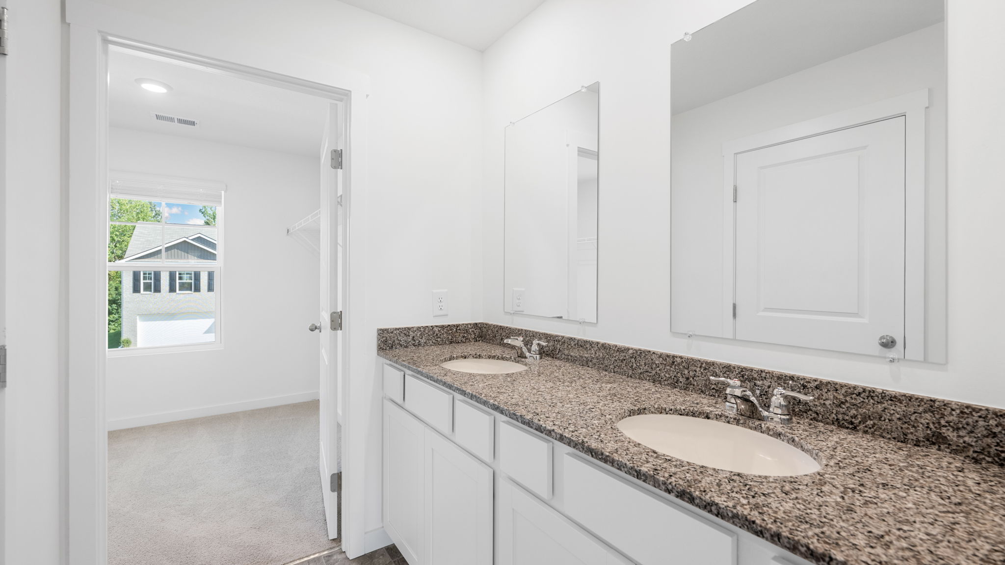 primary bath with vanity and dual sinks