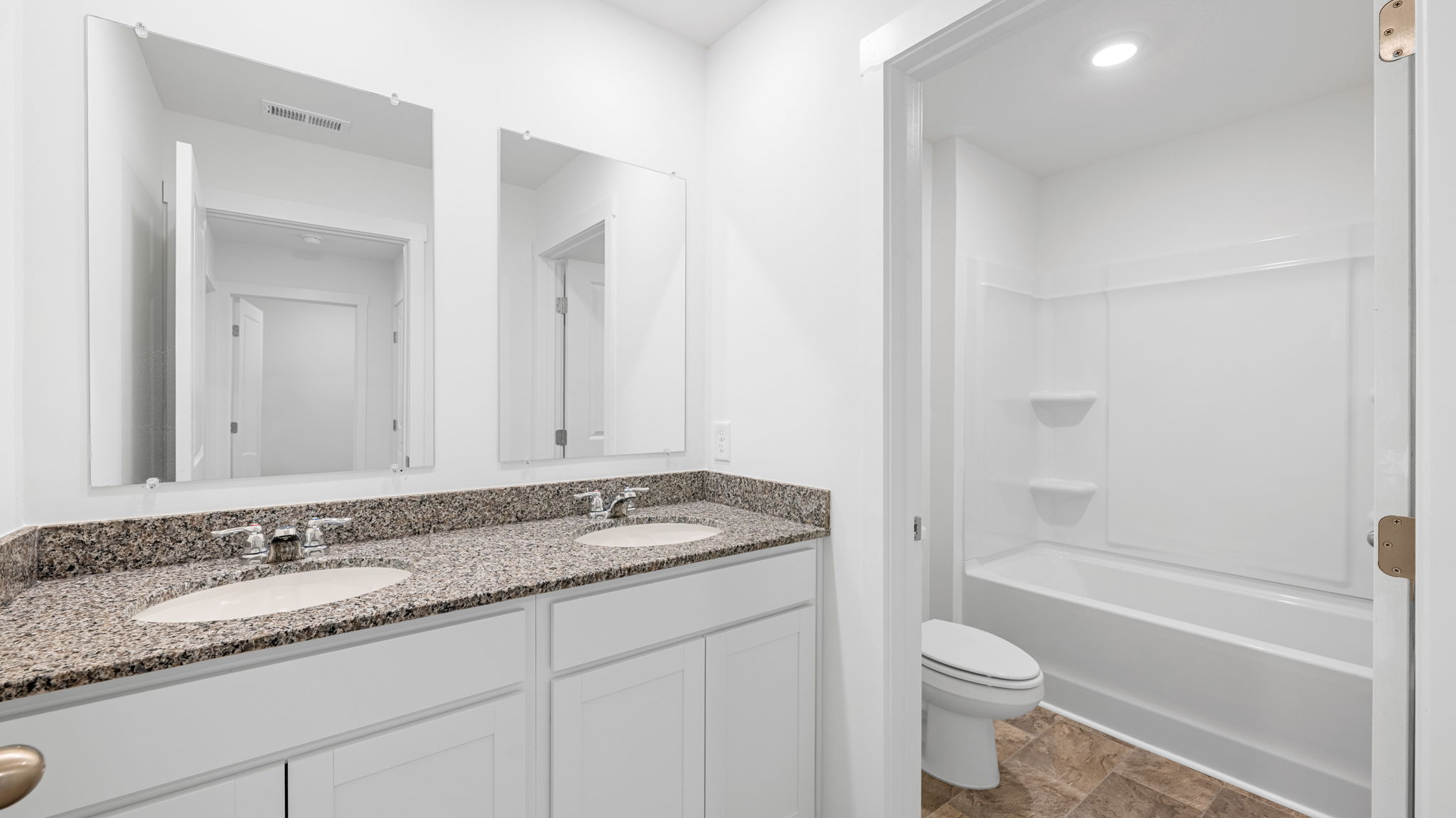 bathroom with granite countertops and tub and shower combo