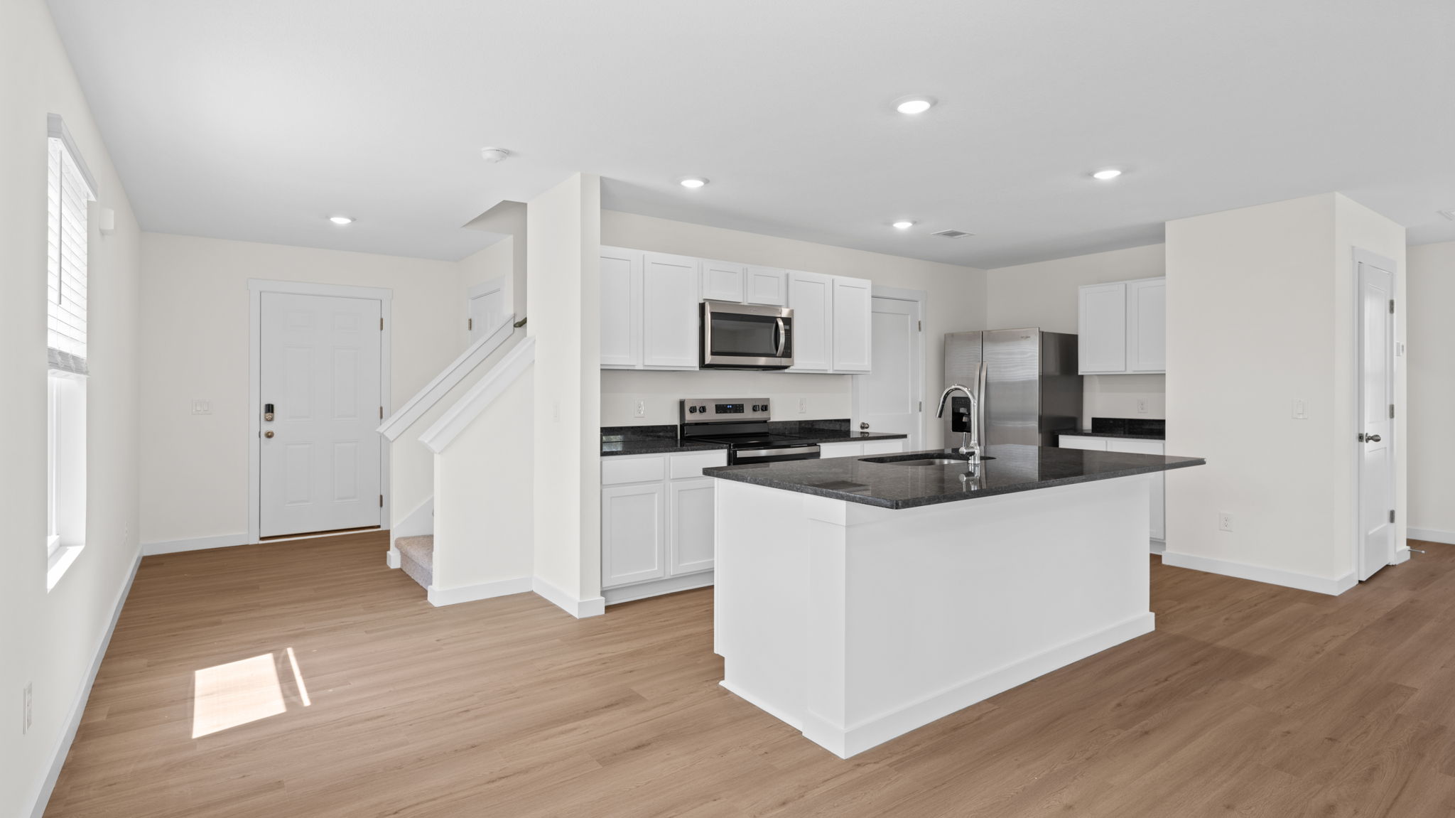 open concept kitchen with island and stainless steel appliances