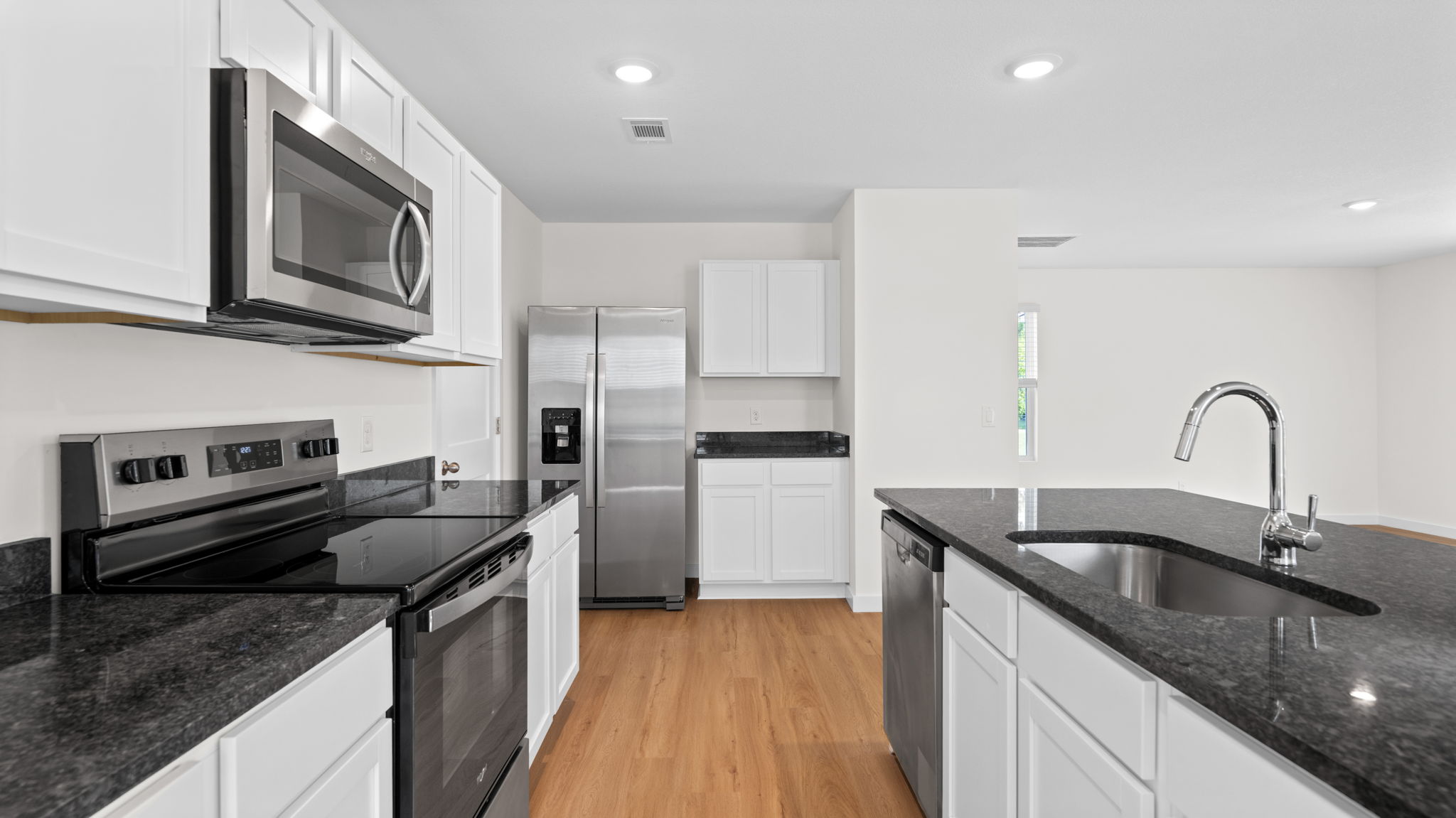 open concept kitchen with island and stainless steel appliances