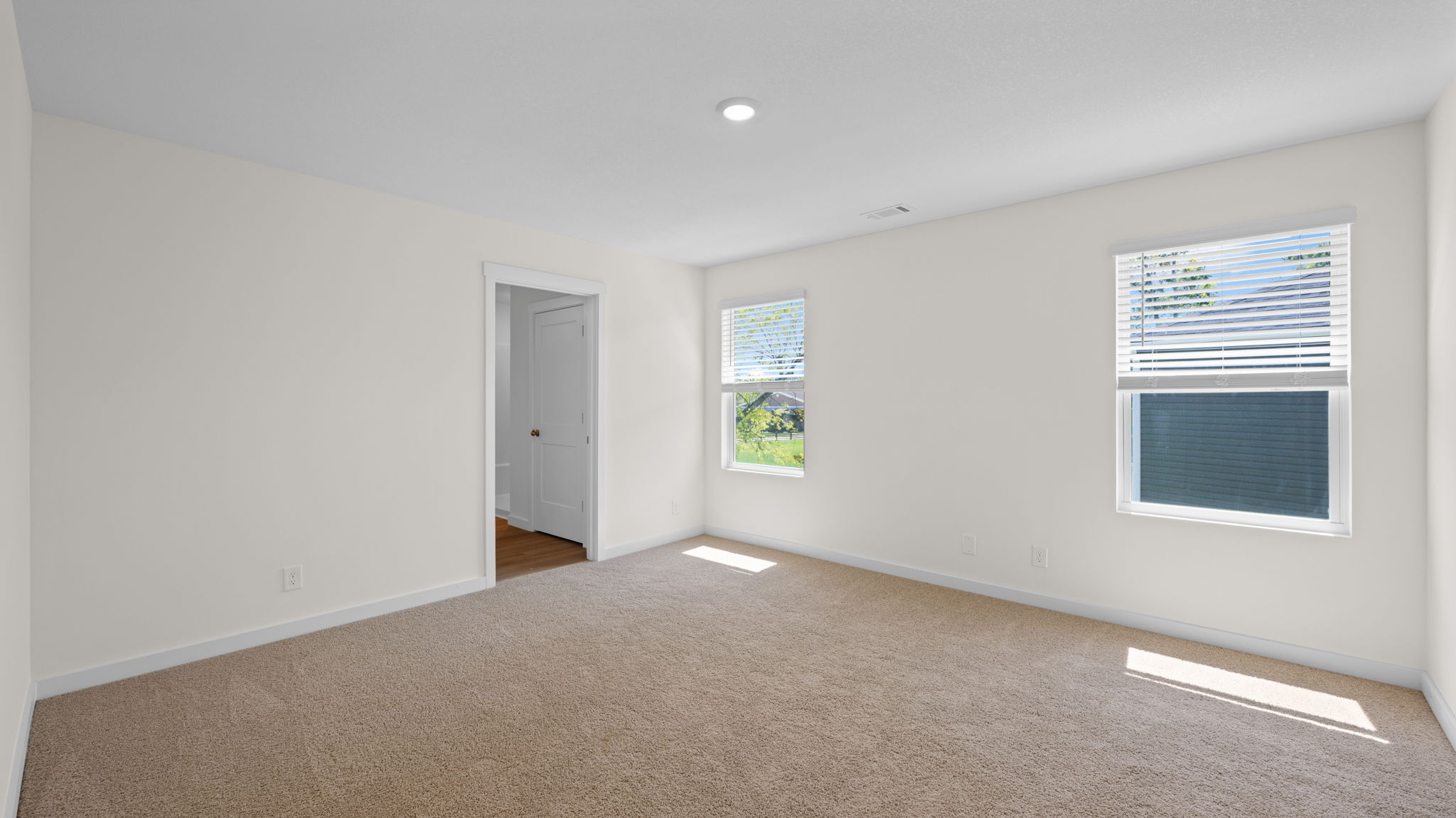 primary bedroom with double windows and ensuite bathroom