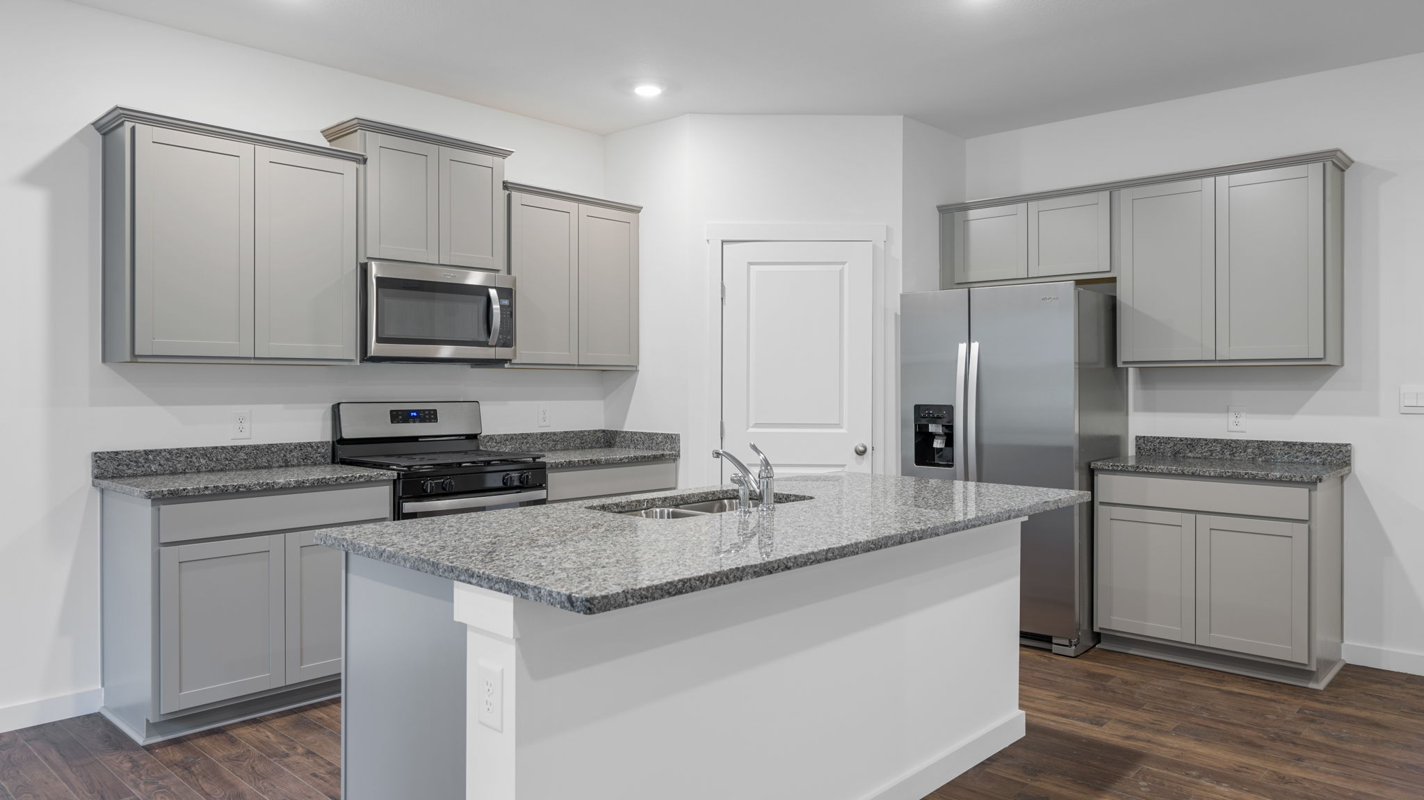 Kitchen with large isalnd and stainless steel appliances