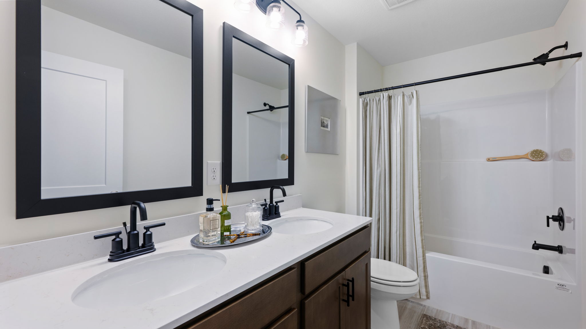 Upstairs guest bathroom with tub and double vanity