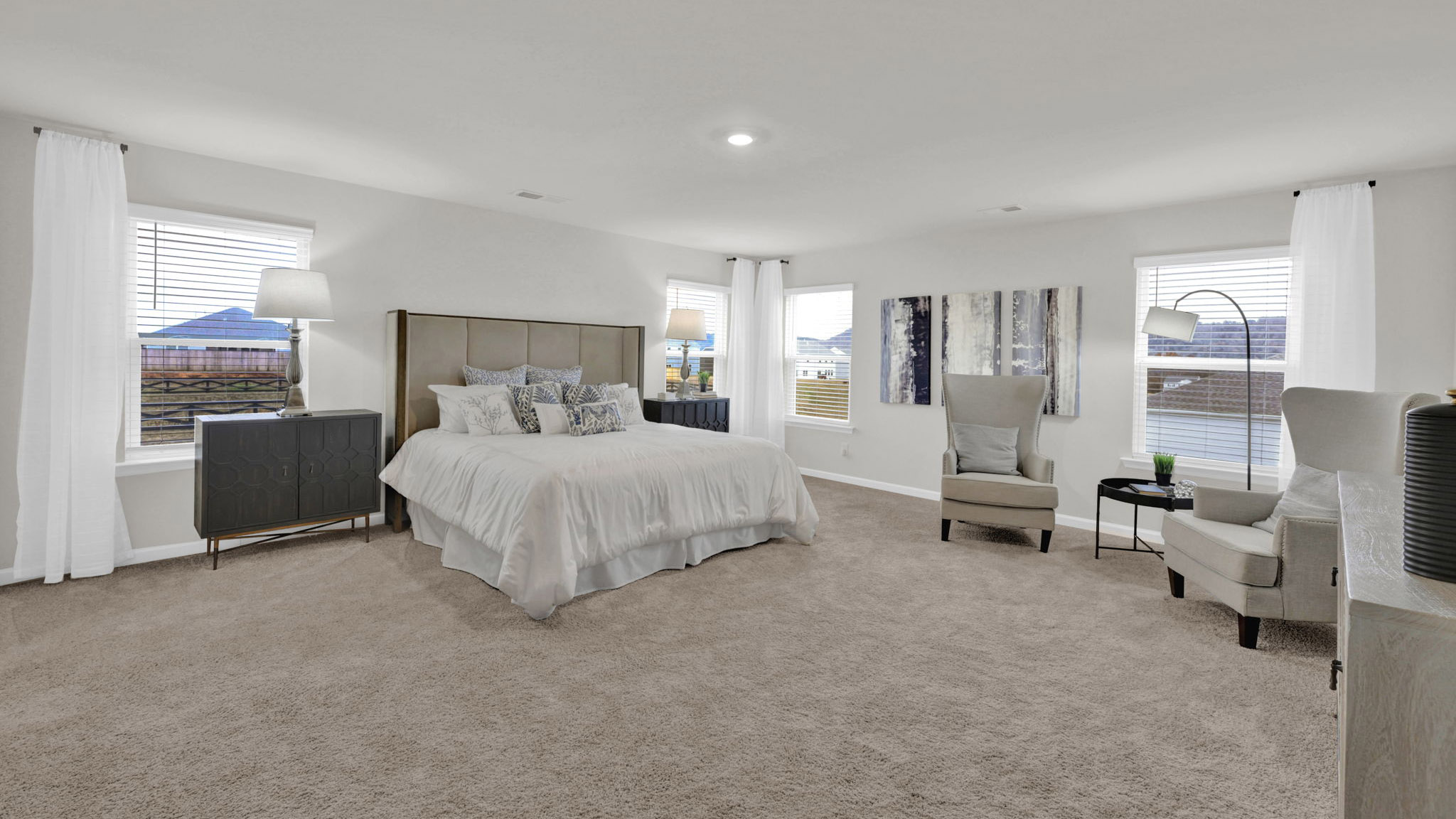 spacious primary bedroom with en suite and windows