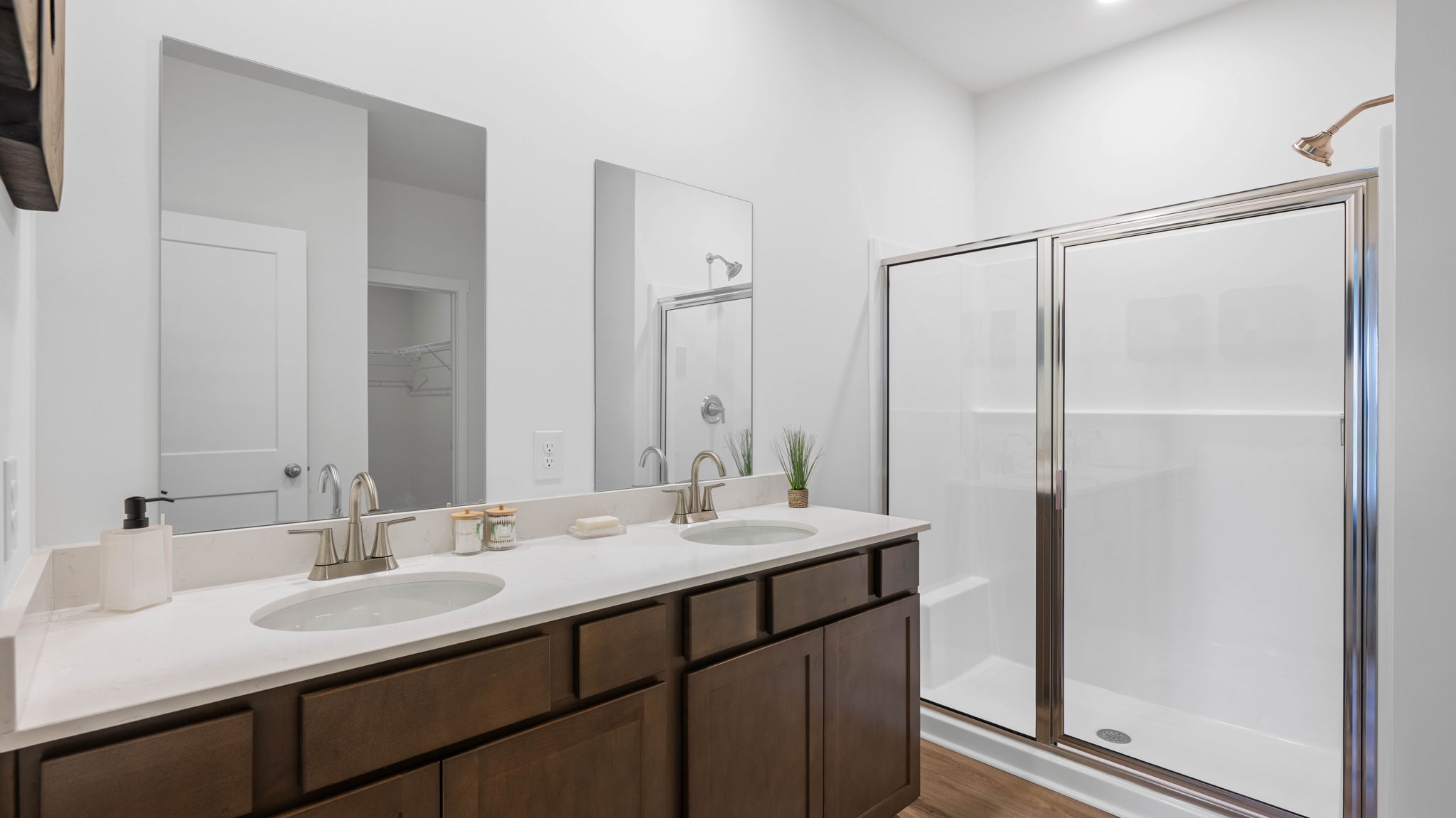 Primary bathroom with glass shower door and double vanity