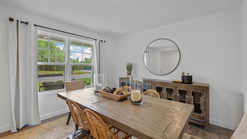 Dining room off entry way of home with double window