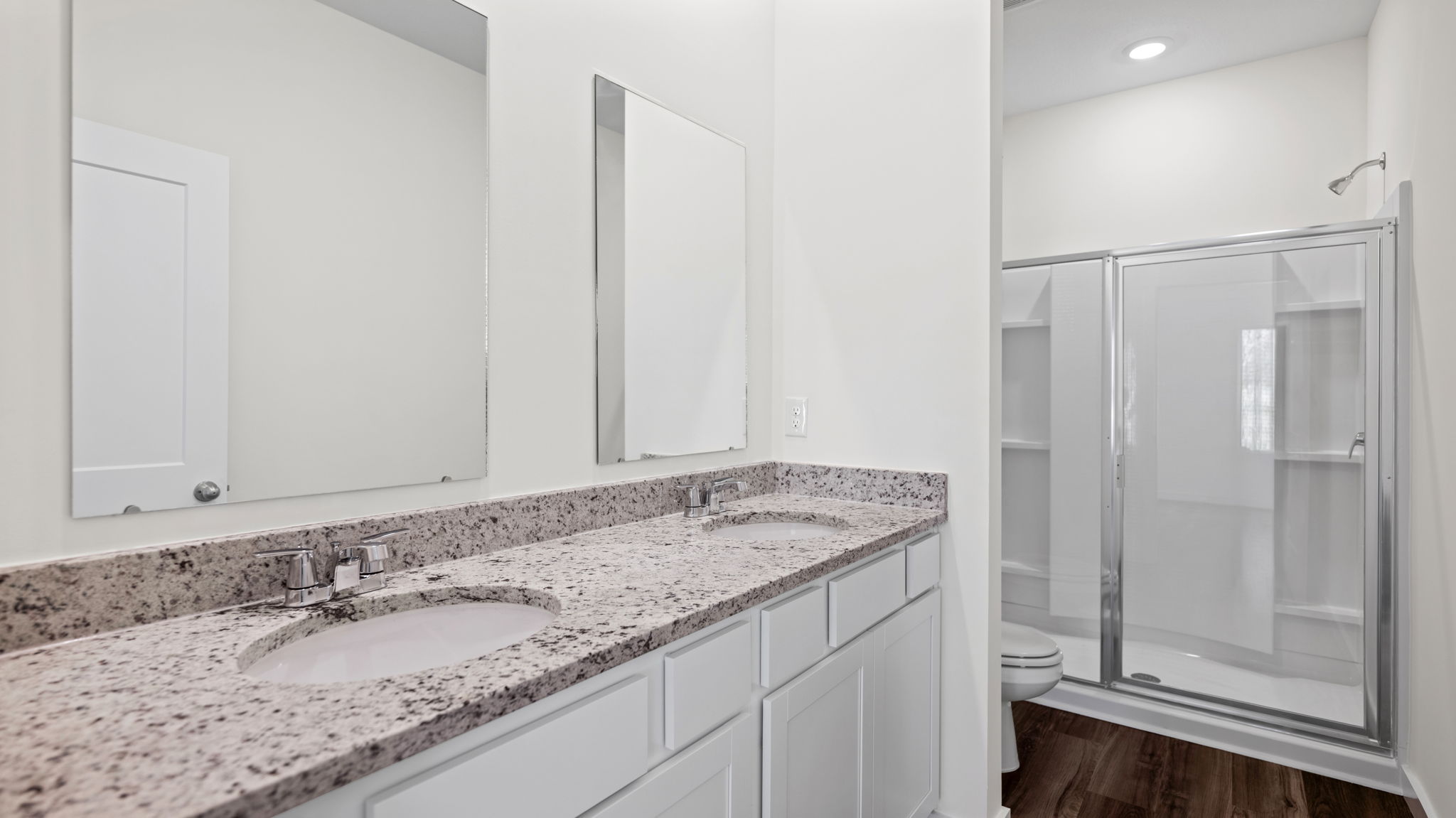 granite vanity and mirrors in bathroom