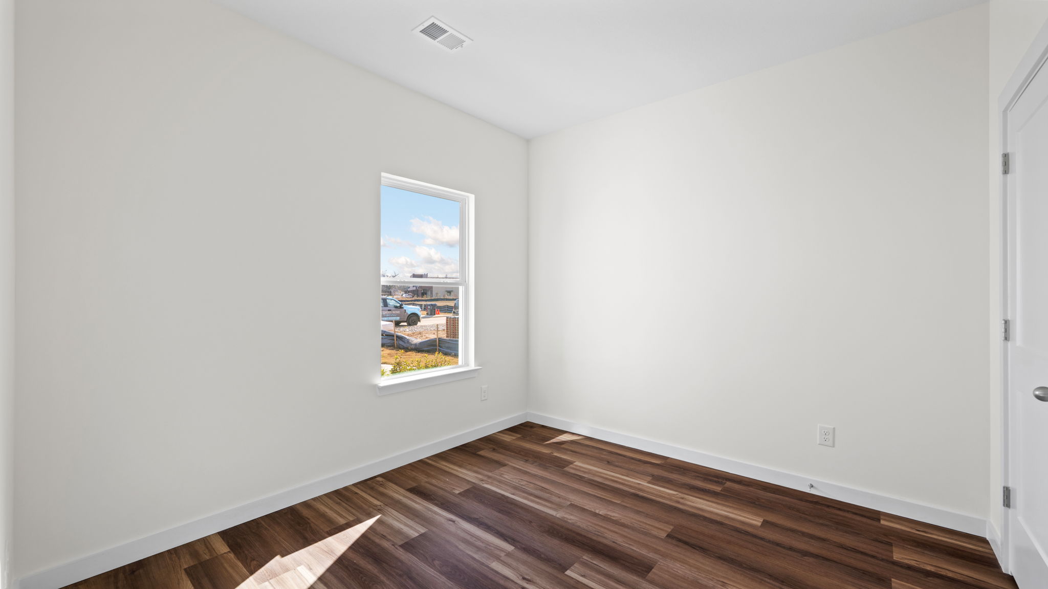 bedroom with lvp flooring and window