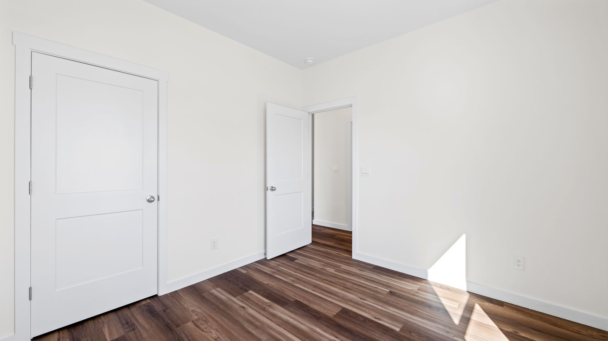 bedroom with lvp flooring and open door