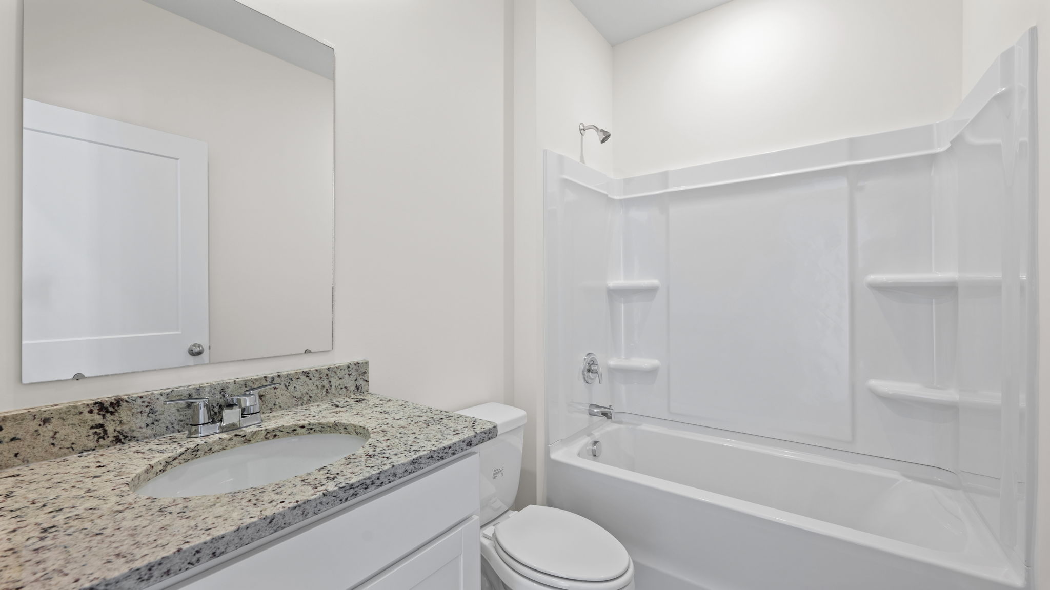bathroom with granite and tub shower combination