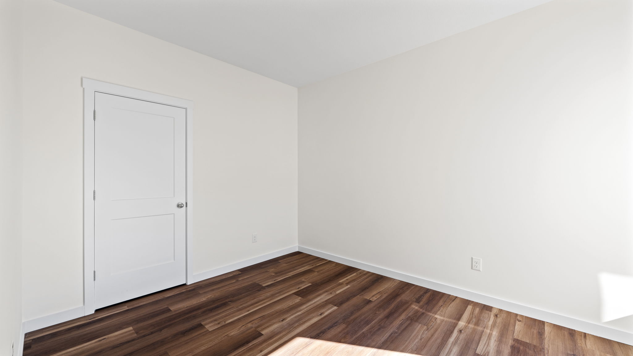 bedroom with lvp flooring and closet door