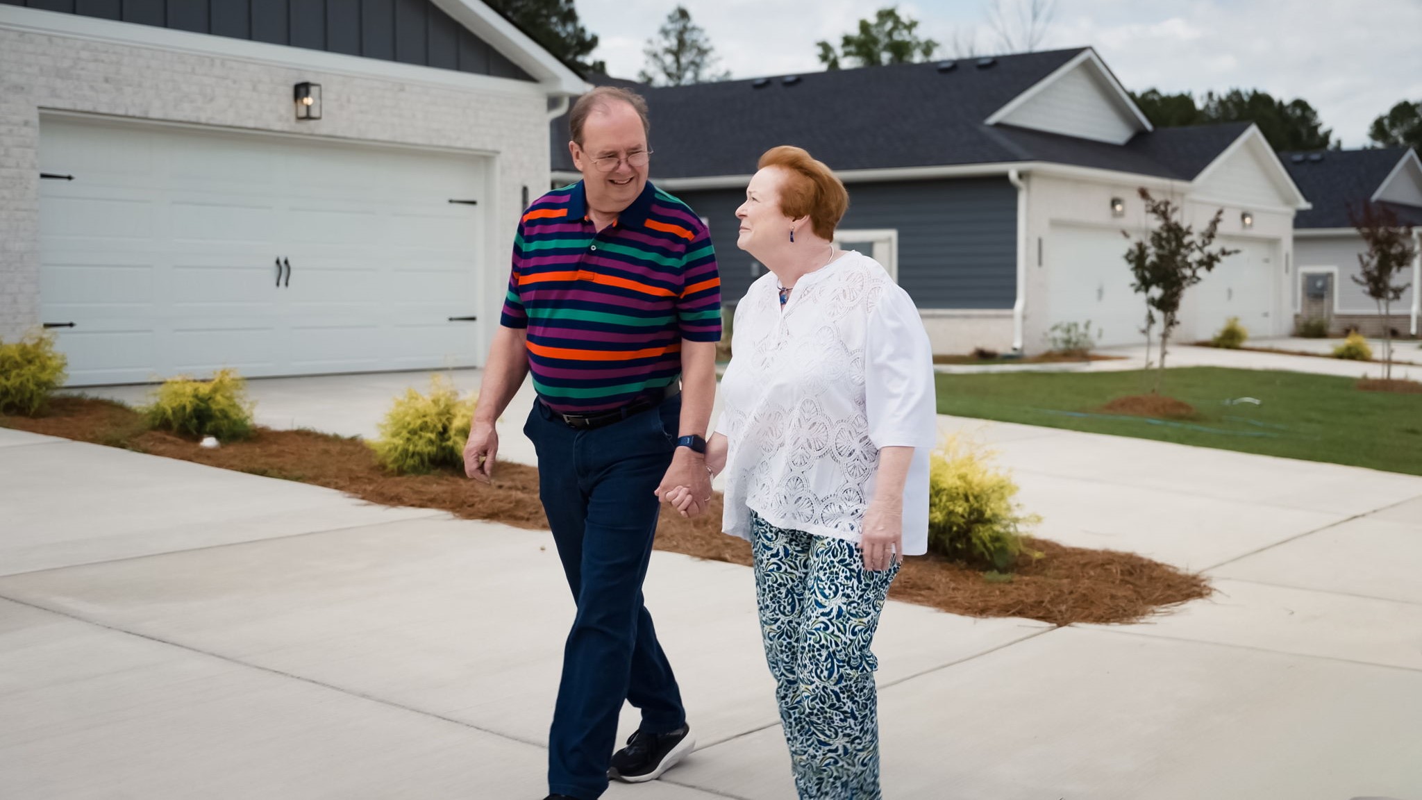a couple walks through the neighborhood