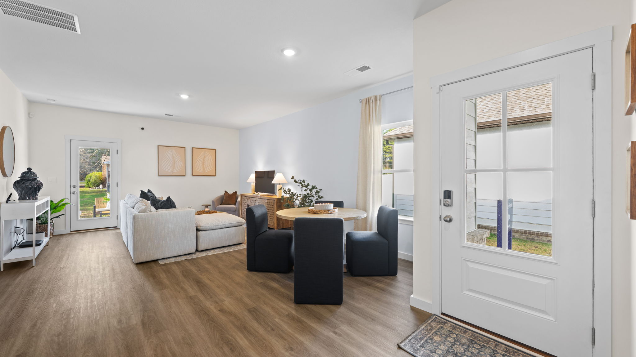 open concept living/ dining area with side door