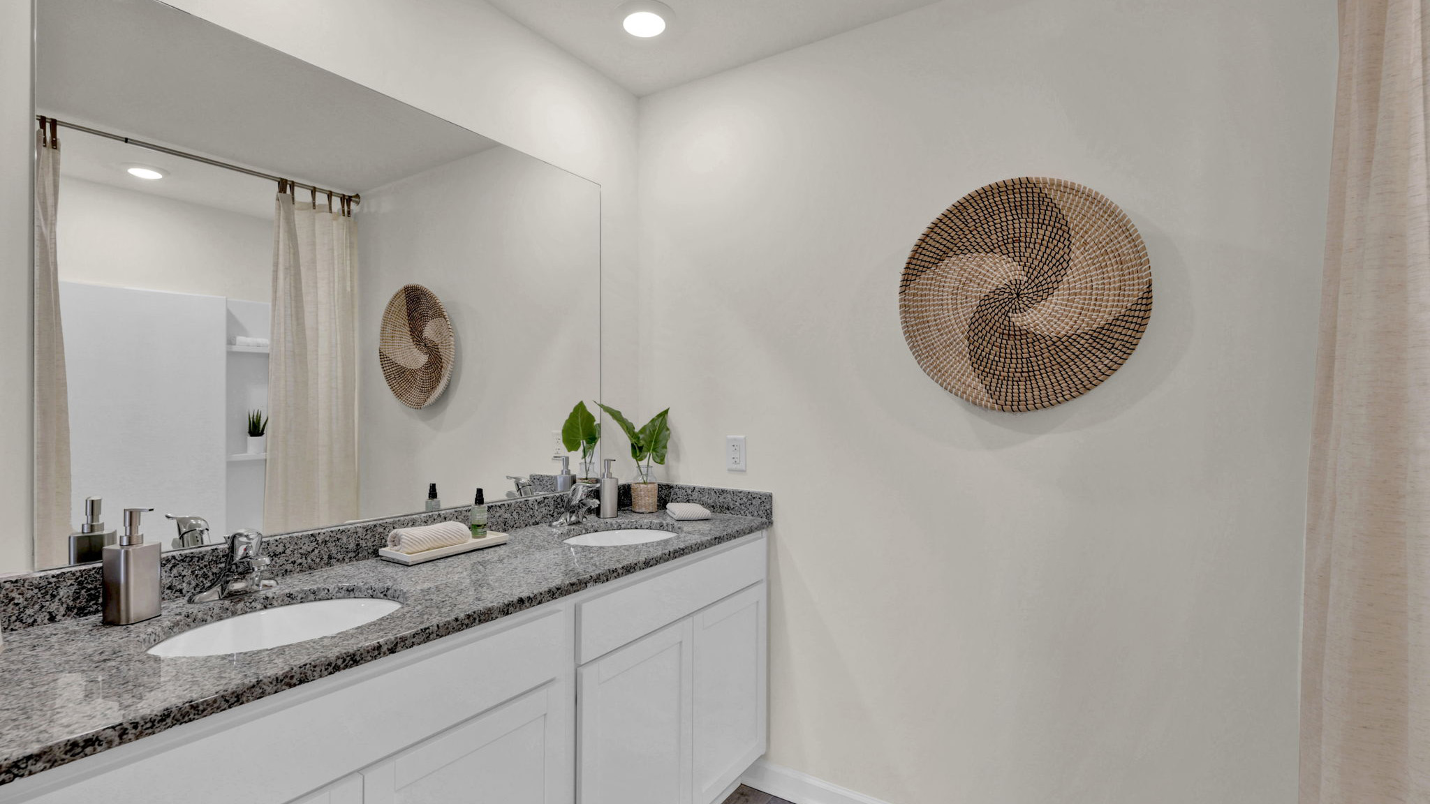 bathroom vanity with cabinets and granite