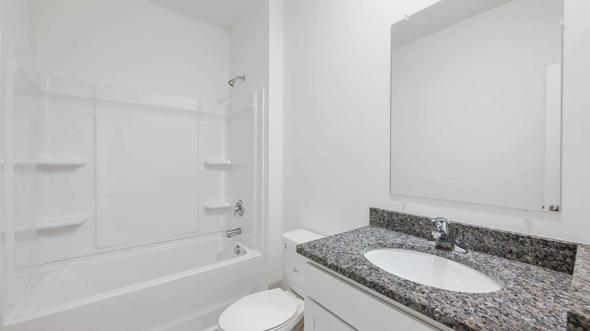 bathroom with granite countertops and mirror