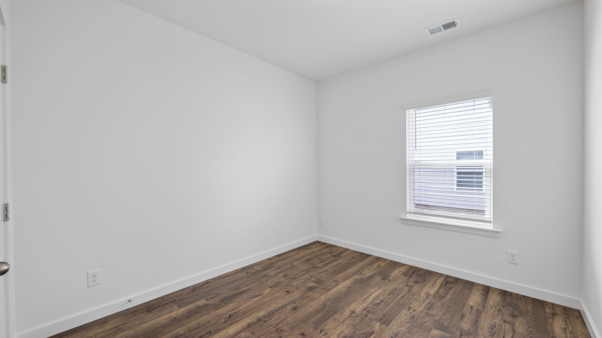 bedroom with lvp flooring and window