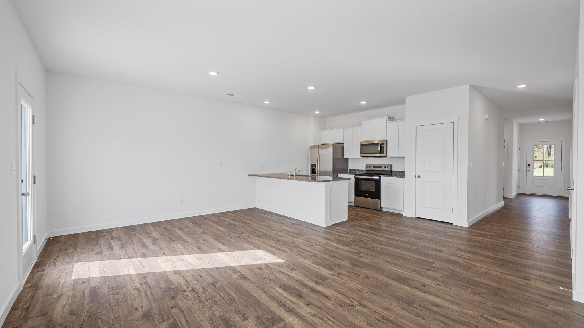kitchen with island and appliances opening into dining area