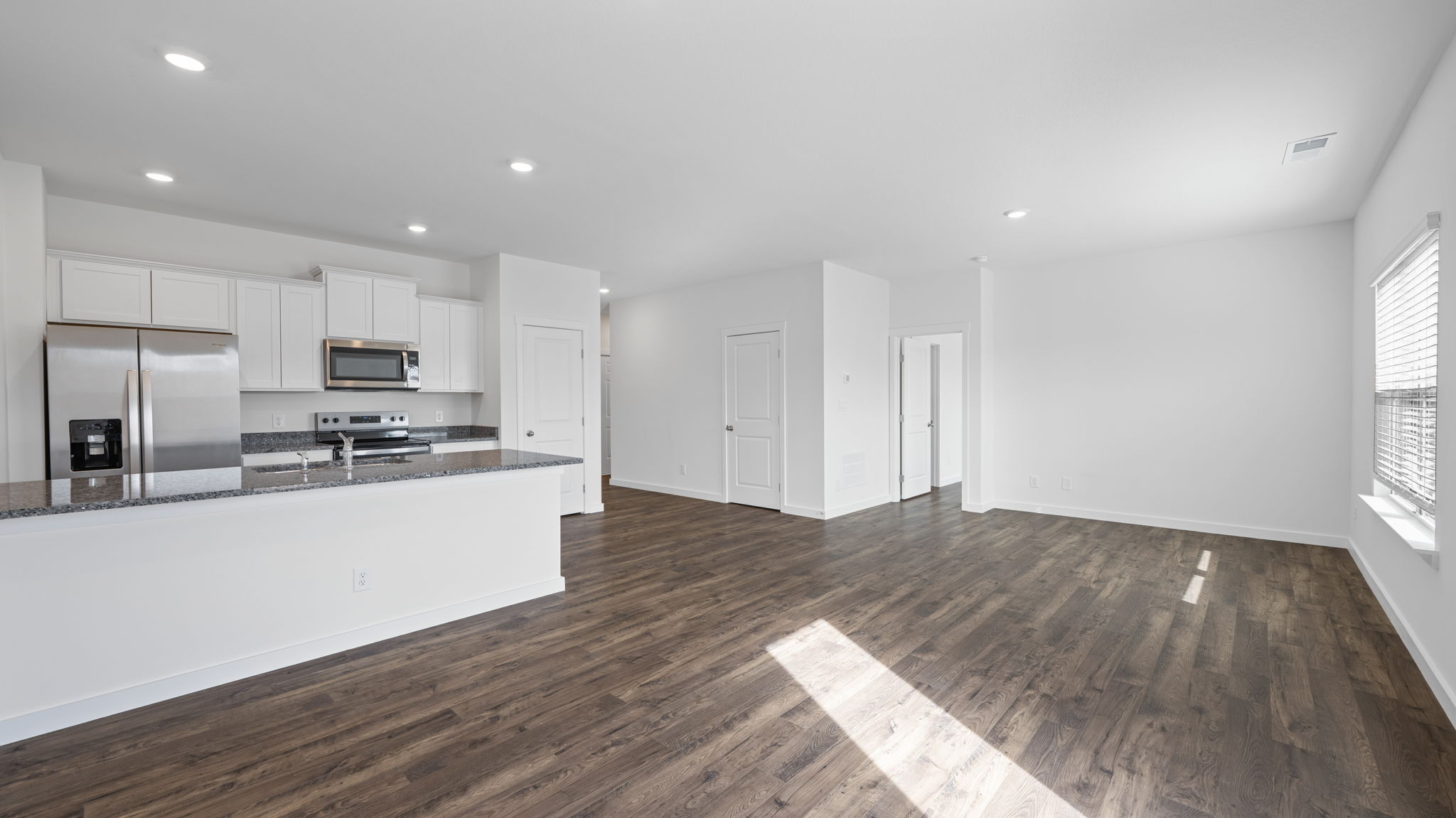 kitchen with island and appliances and open hallway