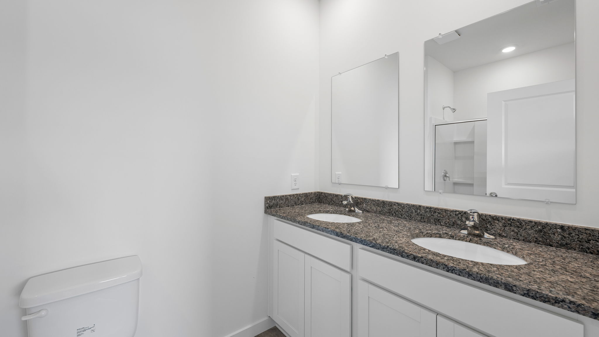 bathroom with granite countertops and dual sink
