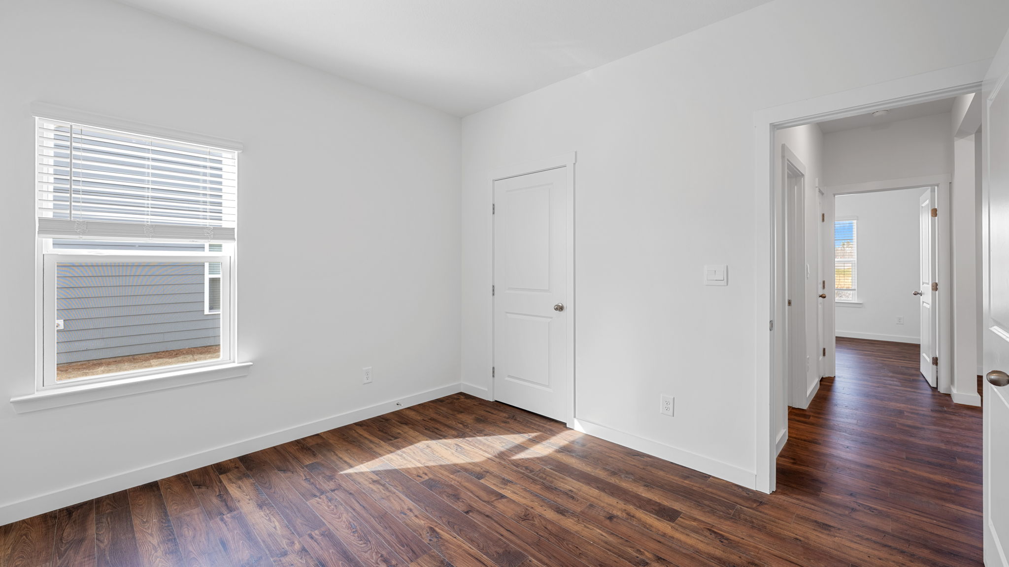 bathroom with solid lvp flooring and window opens into hallway