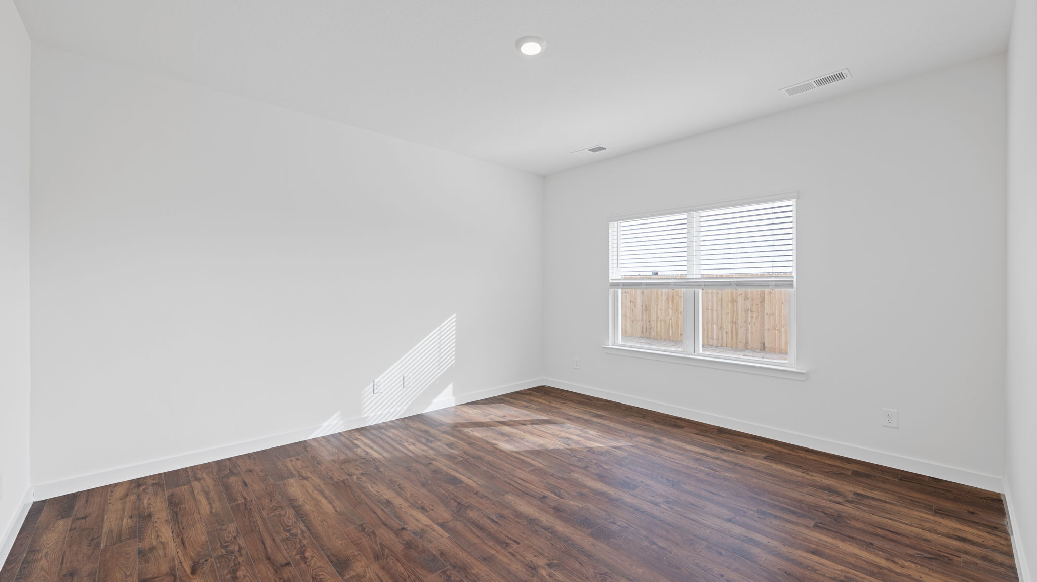 bedroom with lvp solid flooring and window