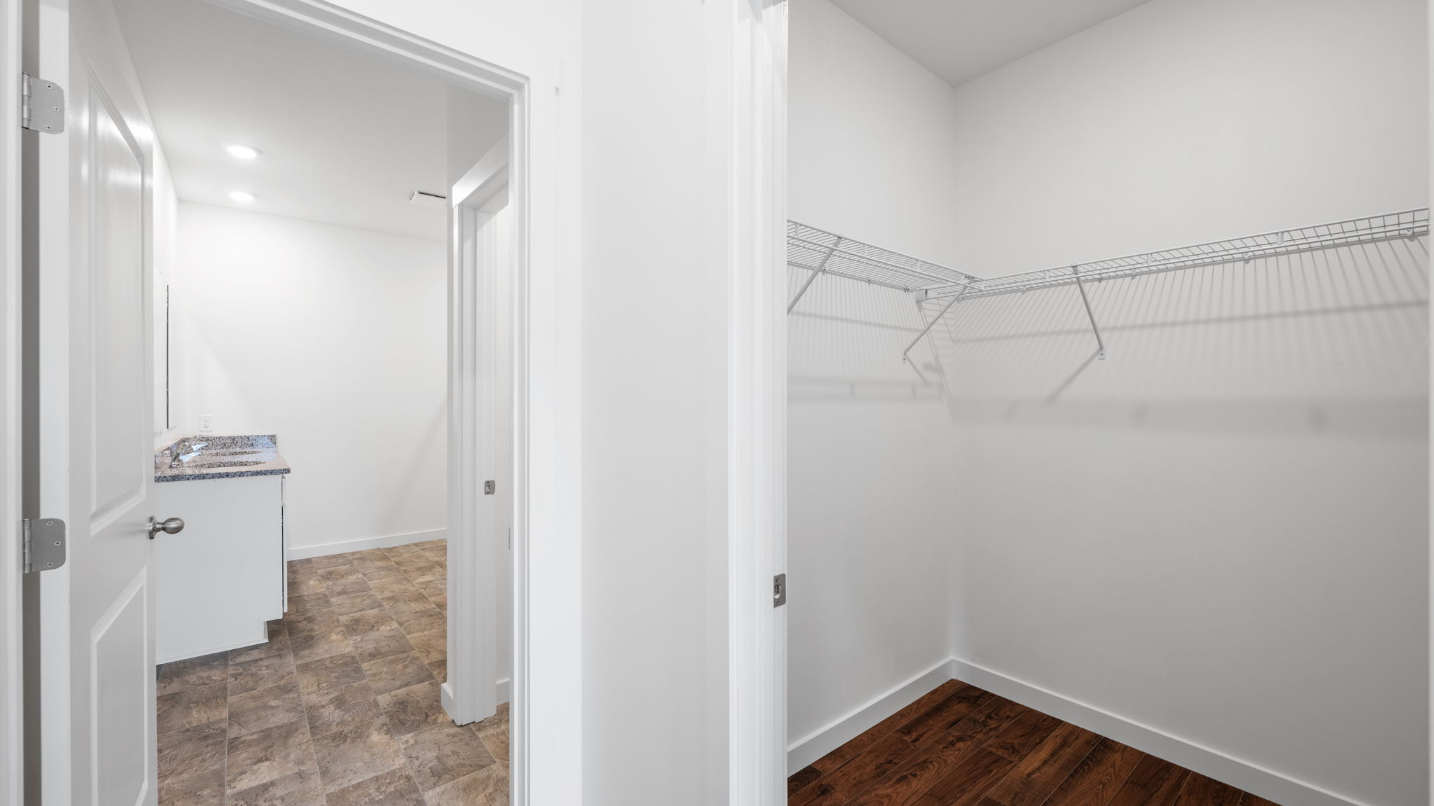 closet with shelving and bathroom