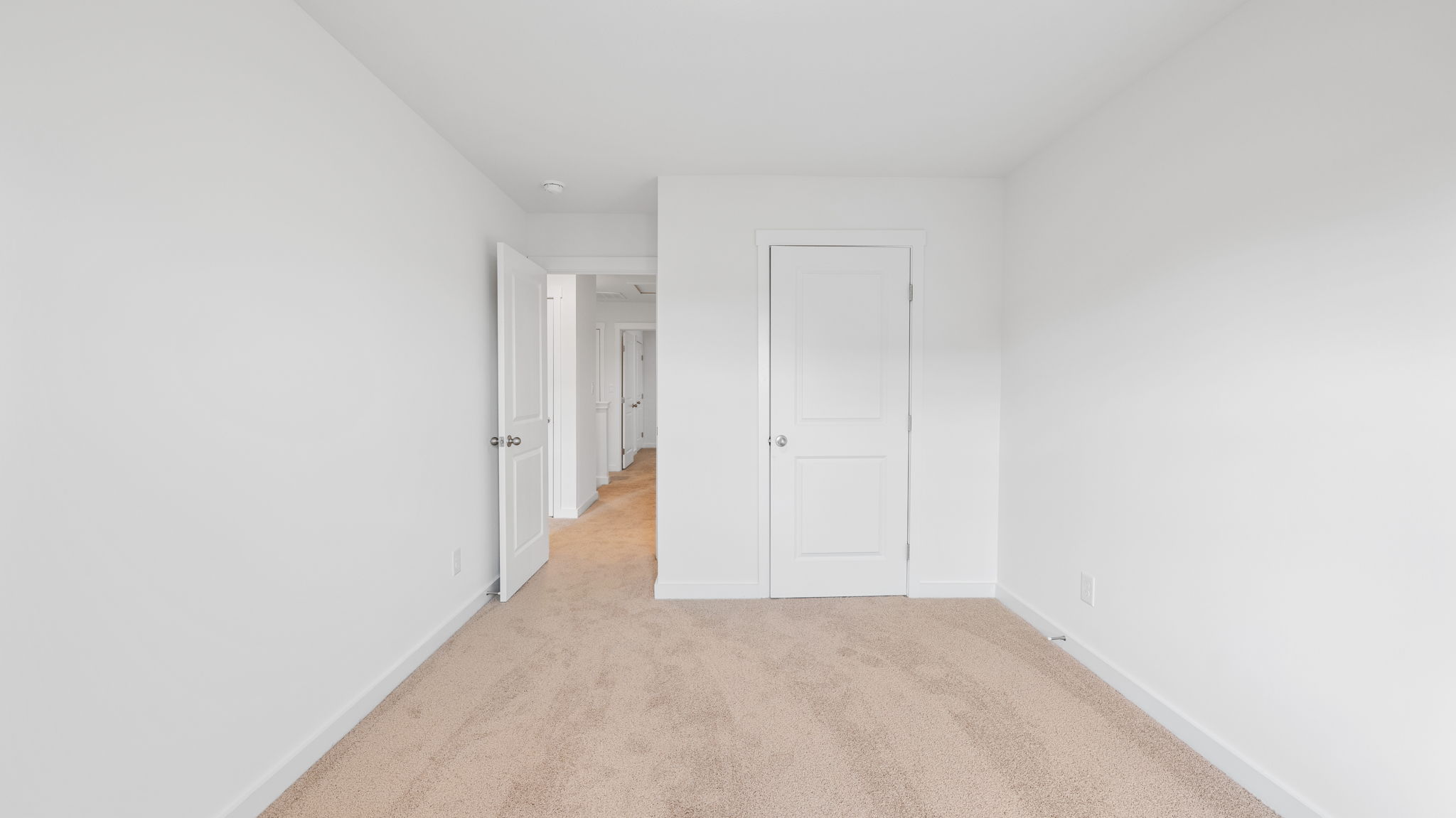 bedroom with carpet and doorway