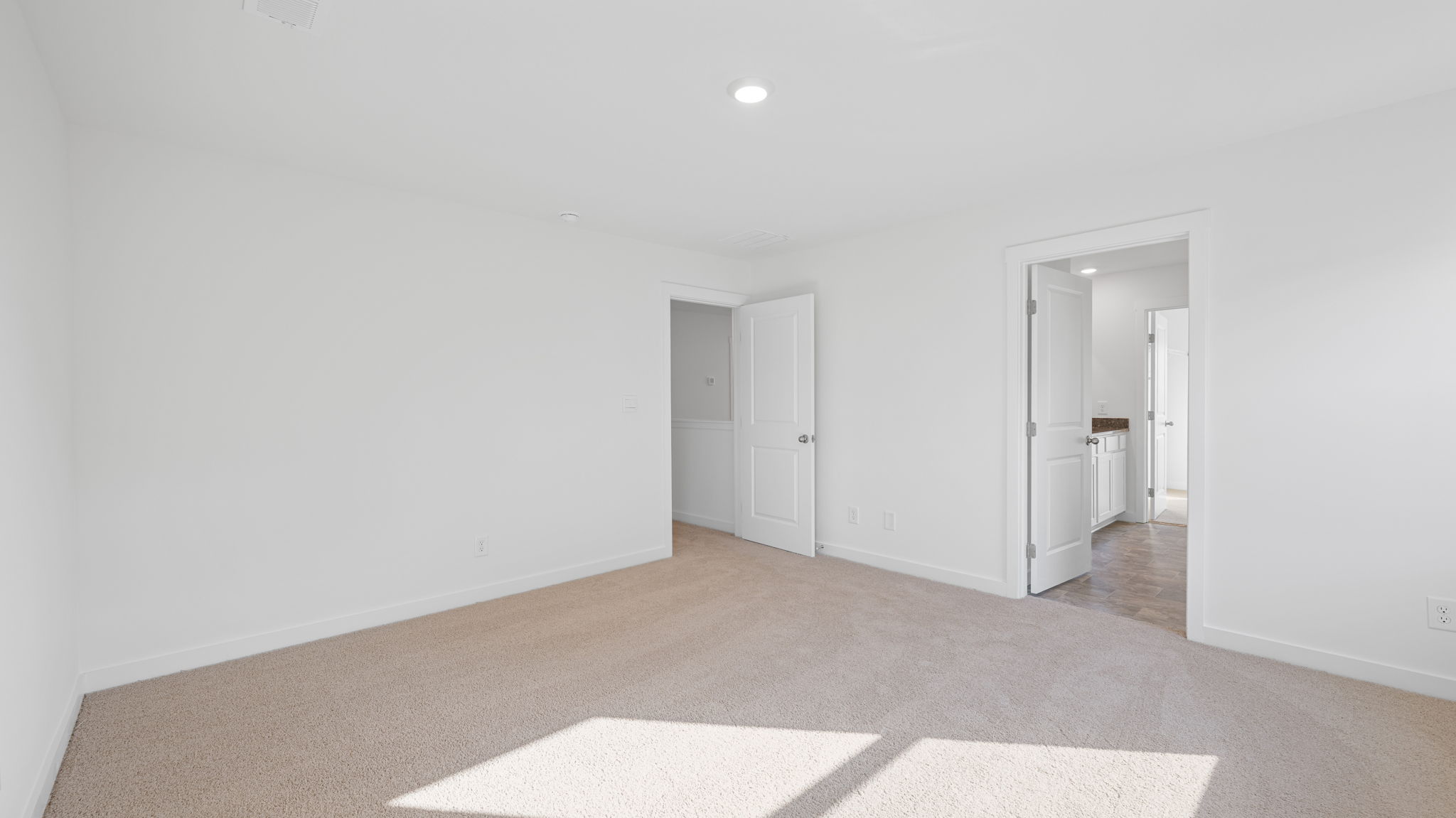 bedroom with carpet and open door