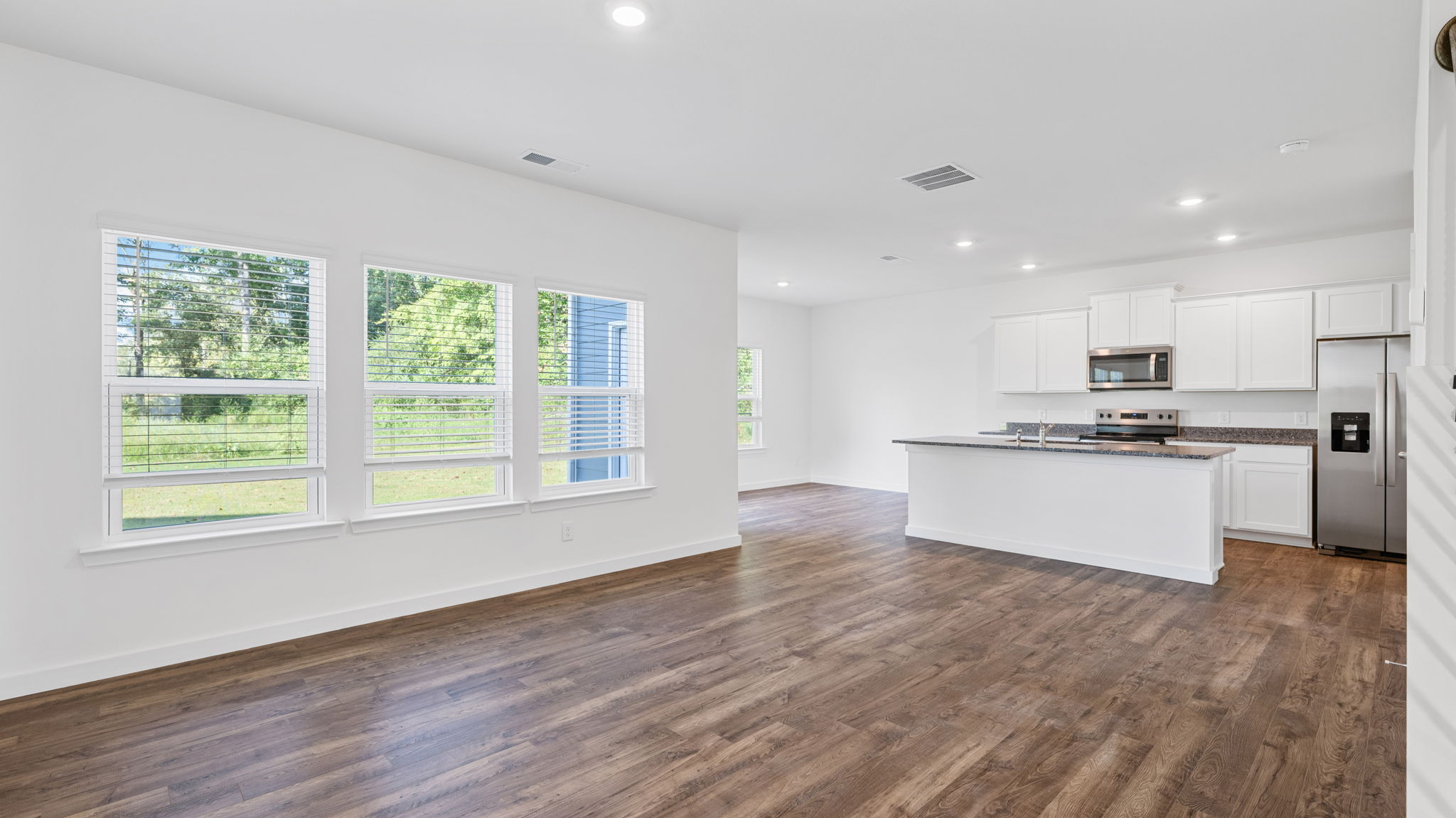 kitchen opening into living room with windows