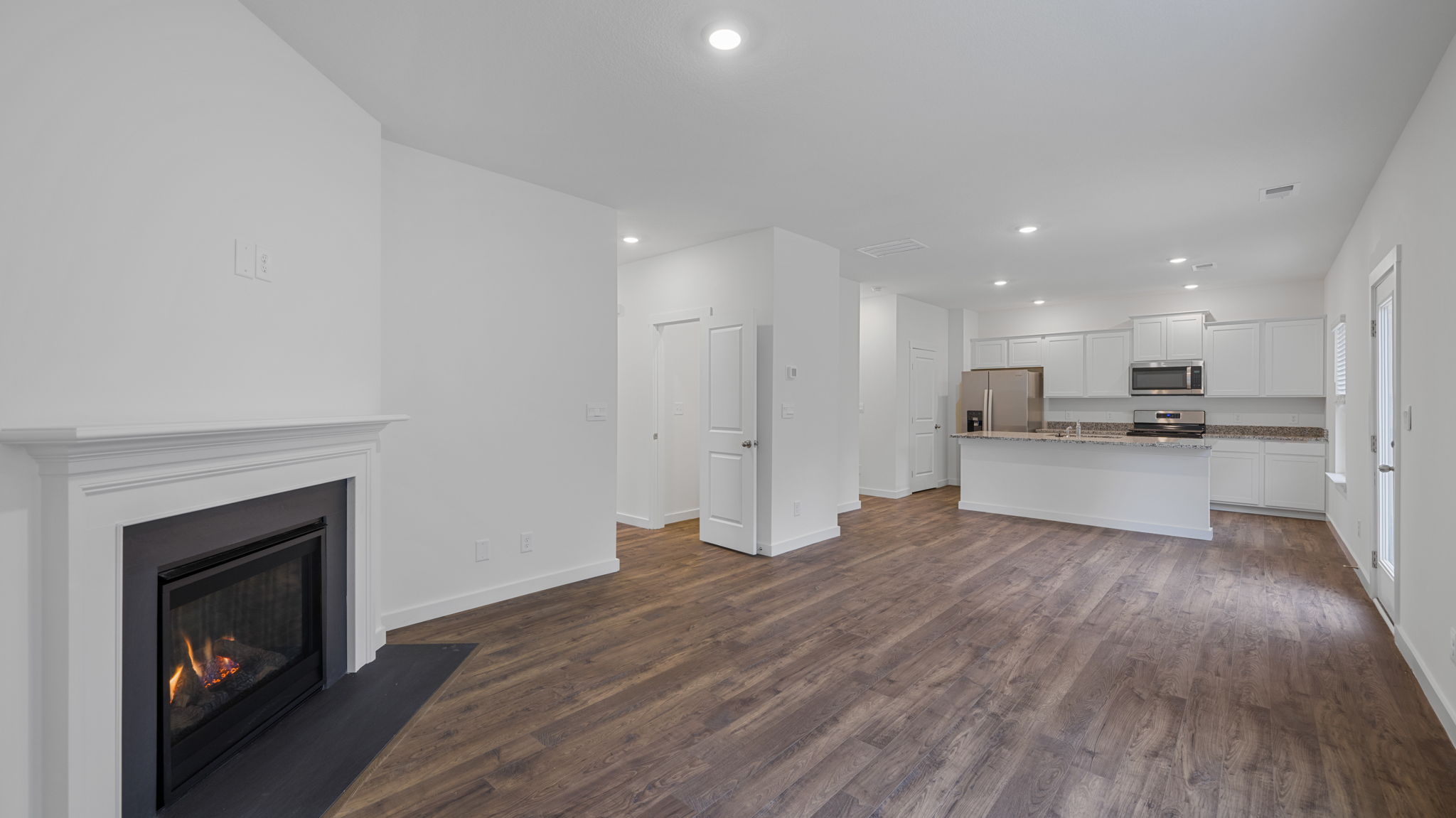 great room with fireplace and solid lvp flooring