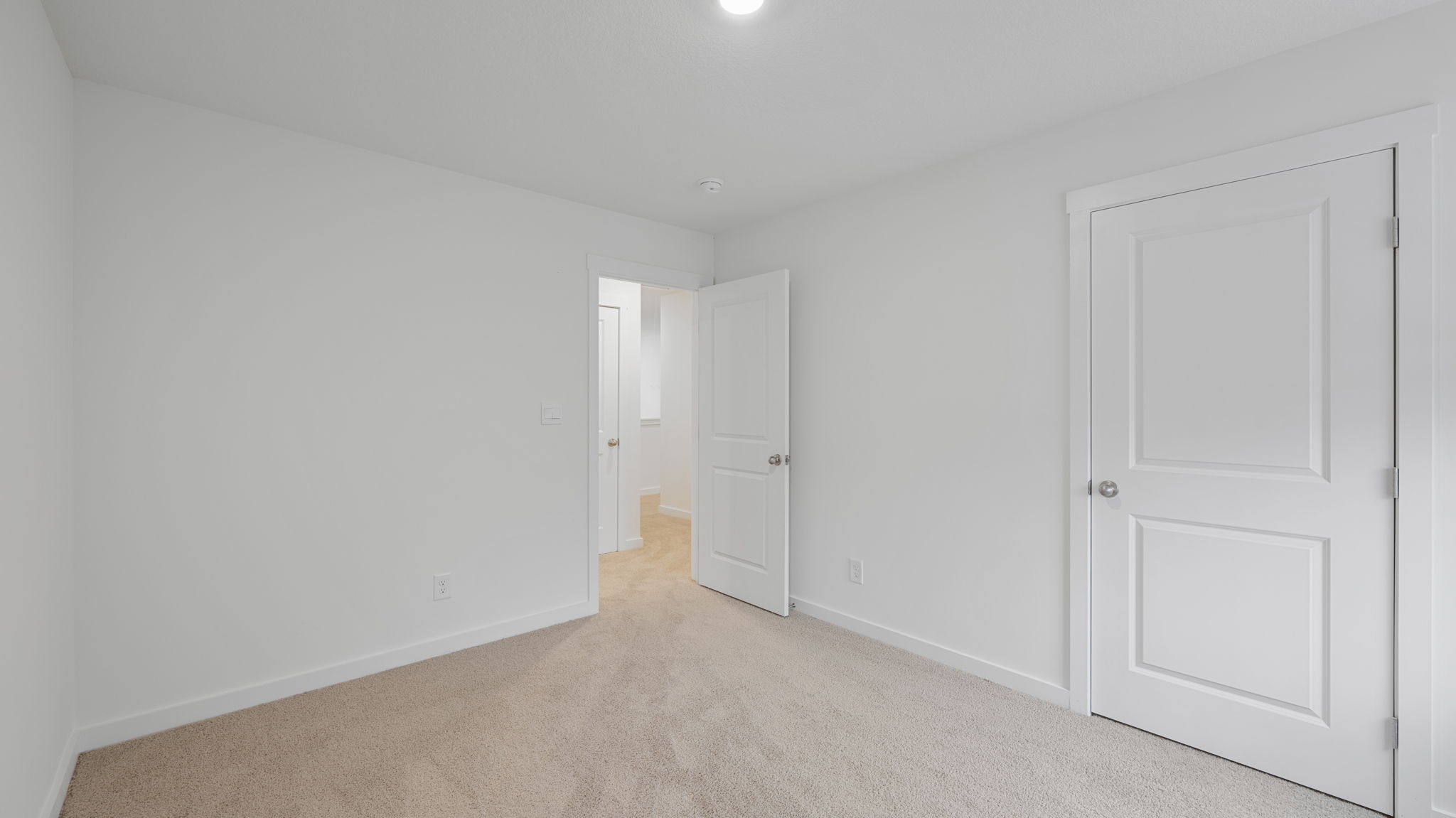 bedroom with carpet and open door